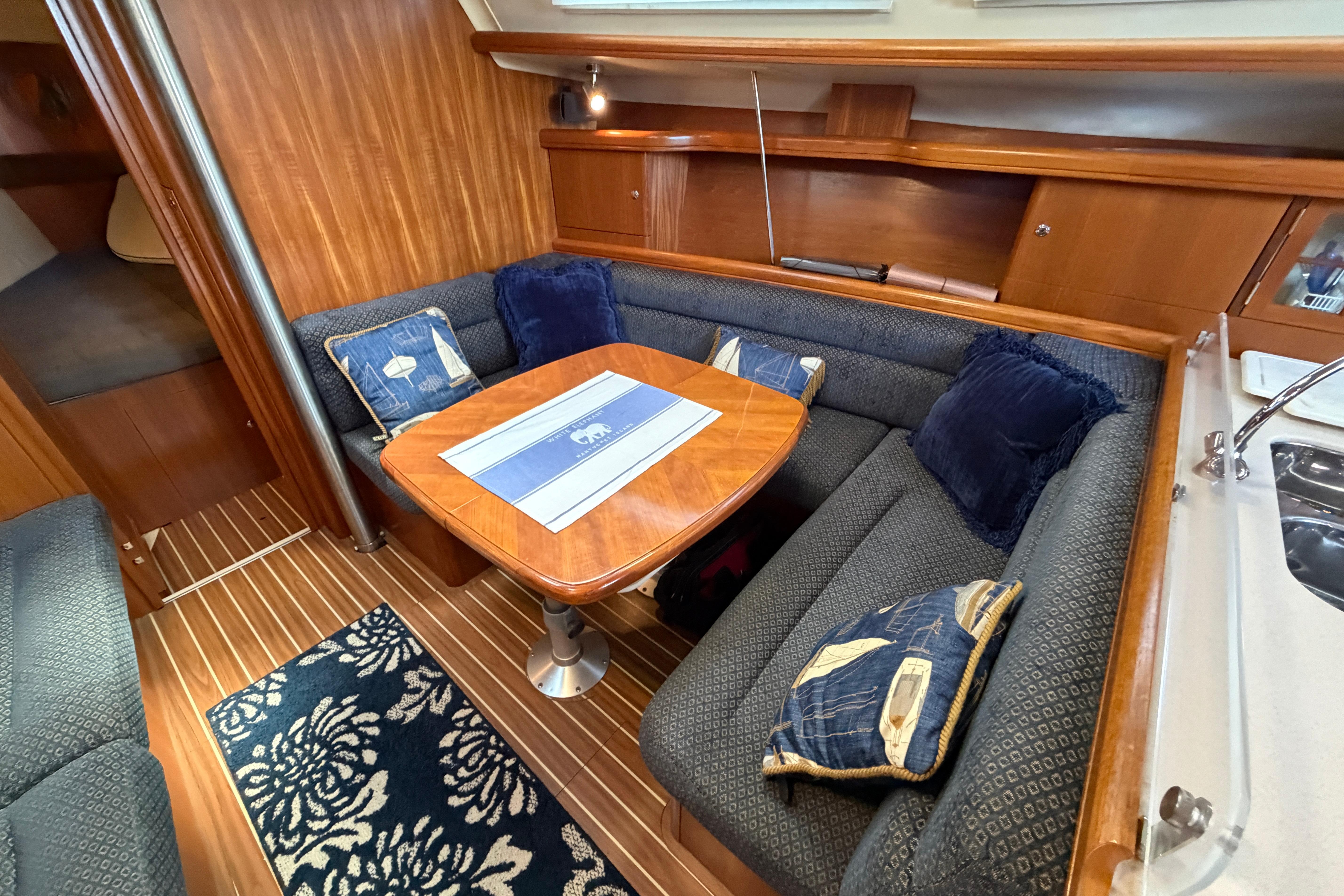 Luxurious 2005 Hunter 38 yacht interior with cozy seating and elegant wooden finishes.