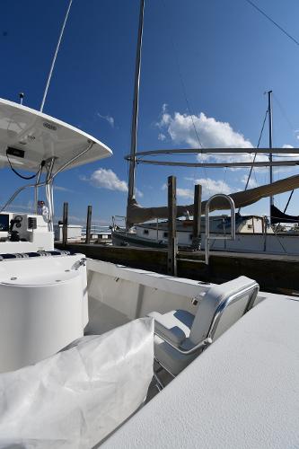 2021 Eastern 248 Center Console boat docked at a marina under a clear blue sky.