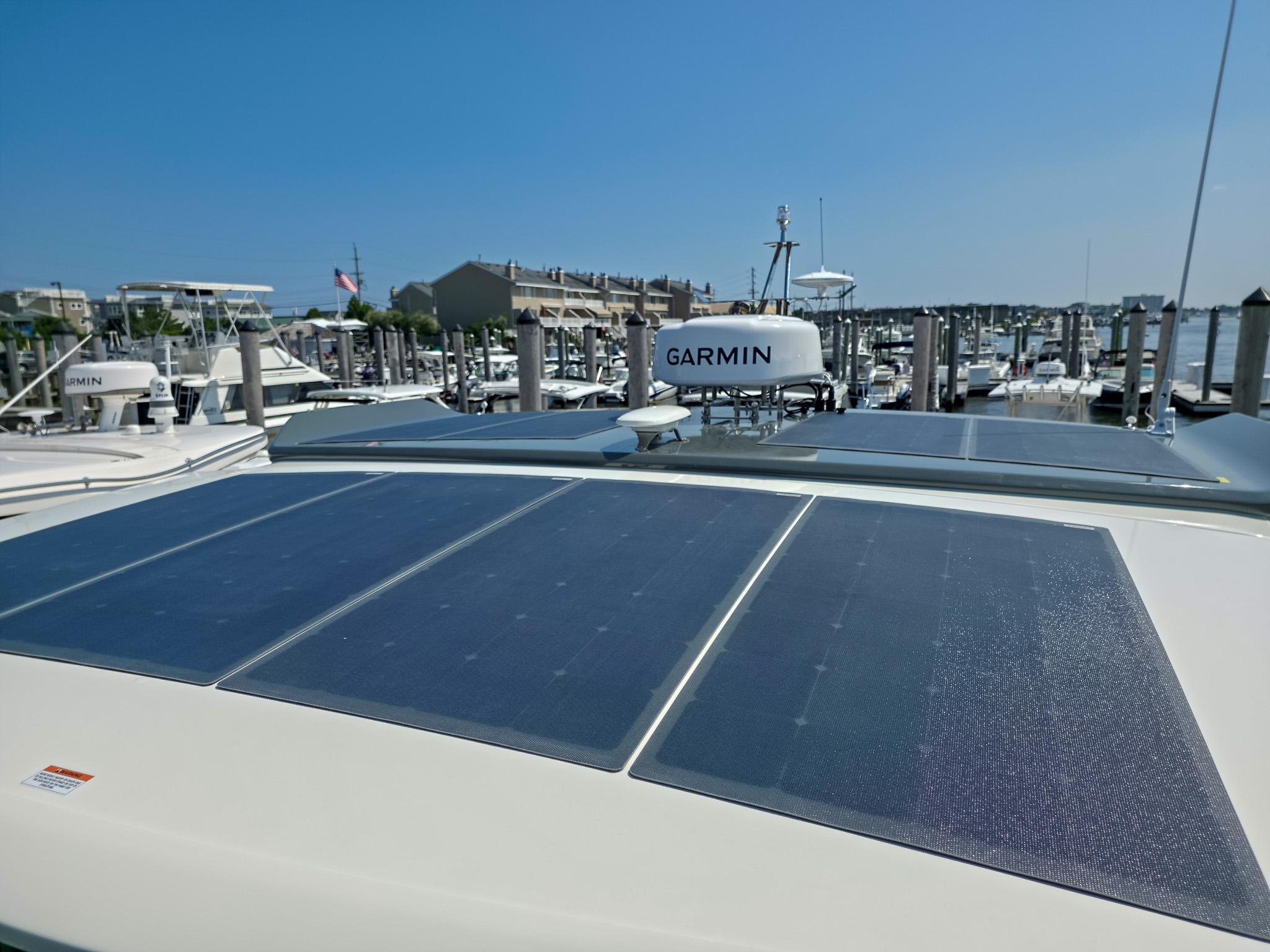 Solar panels on 2026 Marex 440 yacht, docked with Garmin equipment visible.