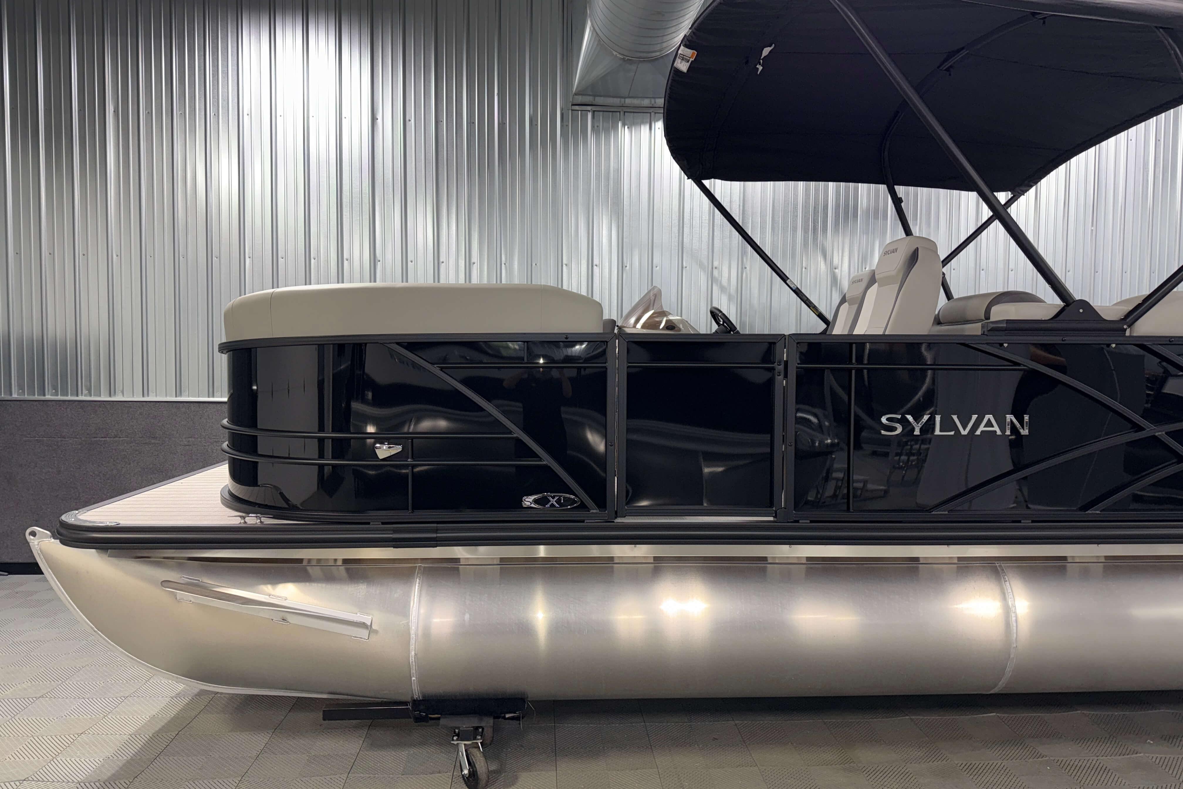 2026 Sylvan Mirage X1 pontoon boat in a sleek indoor setting.