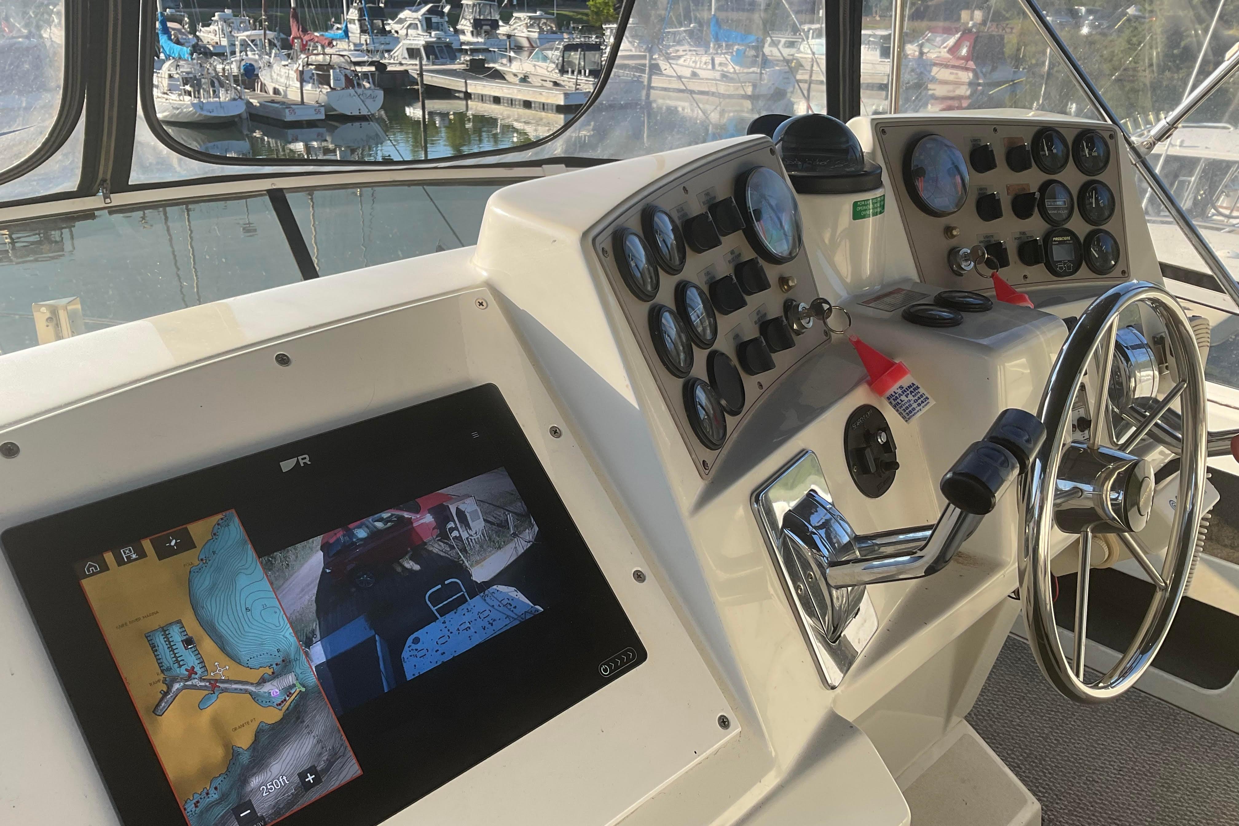 1998 Carver 355 Aft Cabin Motor Yacht helm with navigation display and controls.