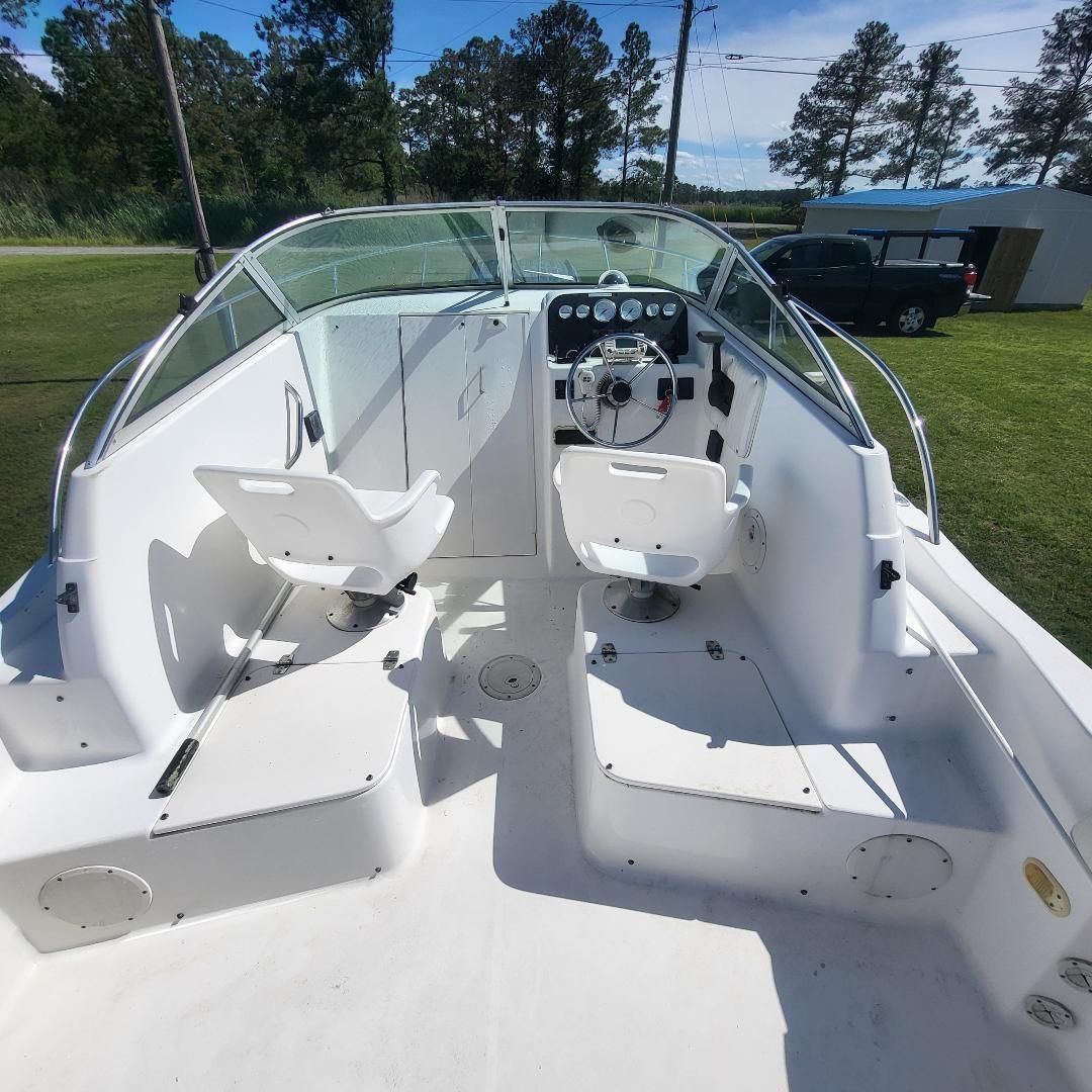 The image shows the cockpit of a 1998 Sport-Craft 211WAC boat with two seats and a helm.