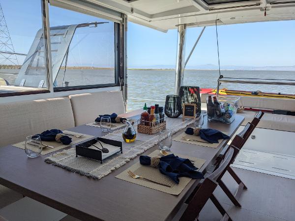 Luxurious dining setup on a 2021 Bali 4.8 yacht with ocean view.