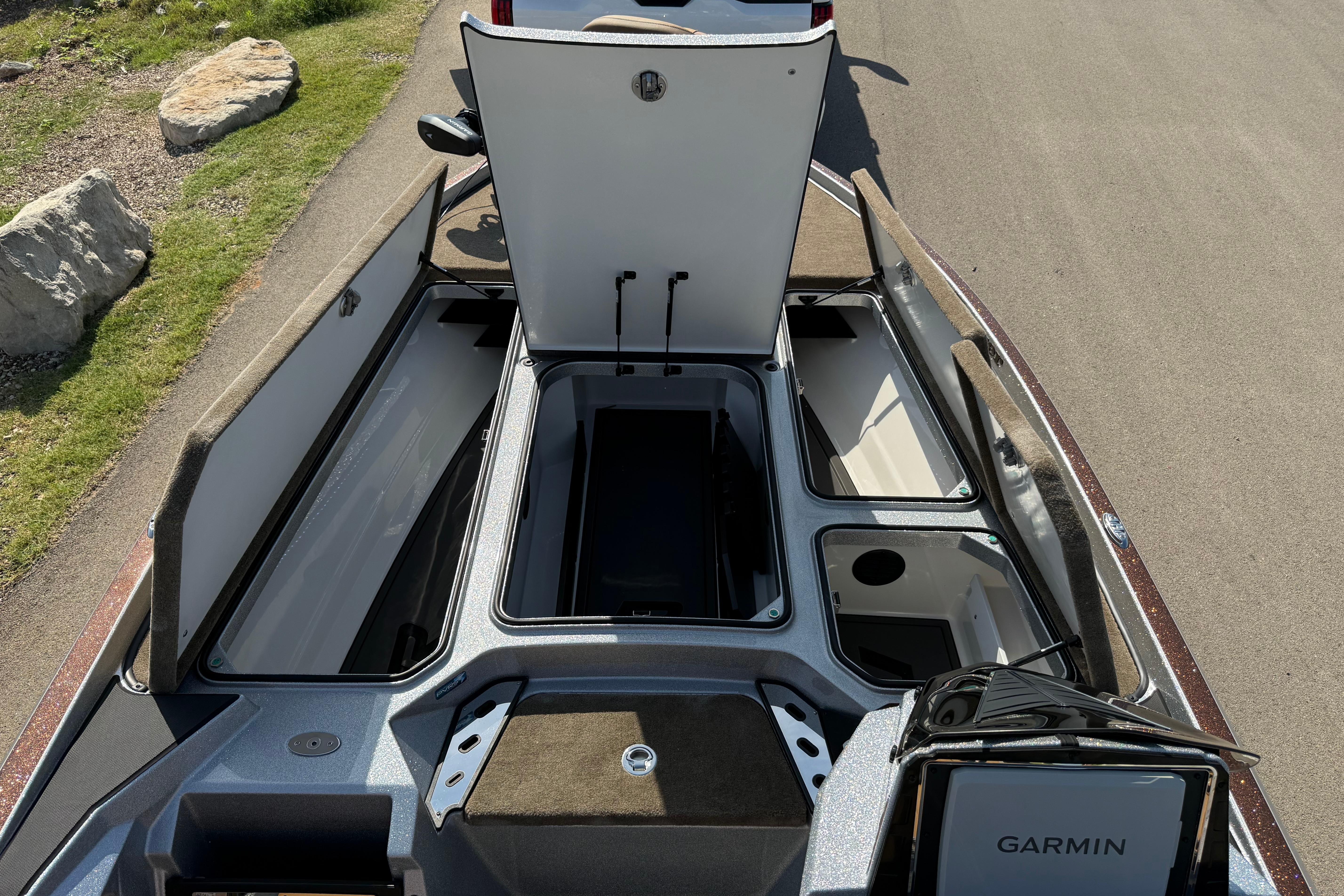 2026 Ranger Z521R boat with open storage compartments and Garmin equipment on a sunny day.
