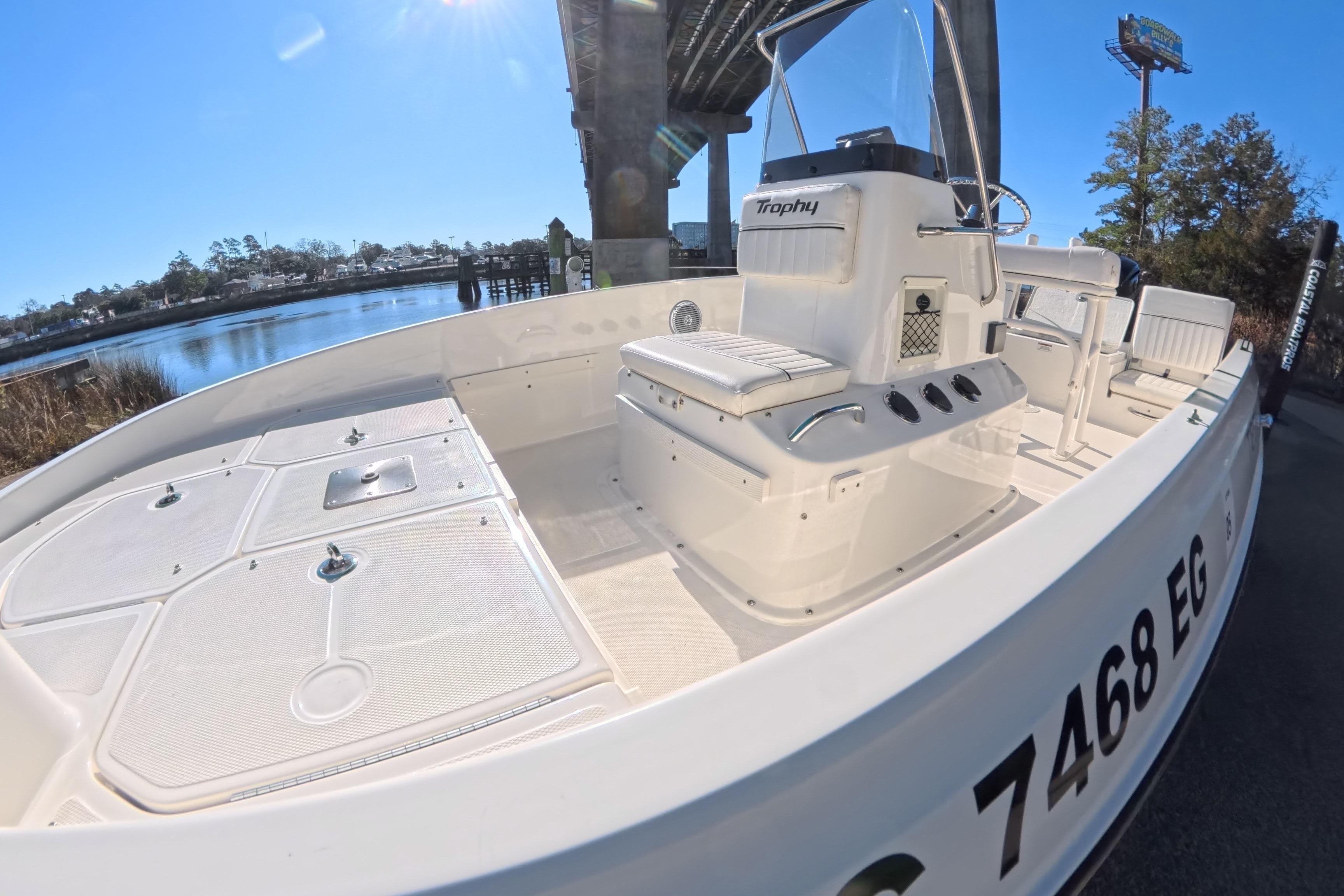 2023 Trophy T-18 boat docked under a bridge on a sunny day.