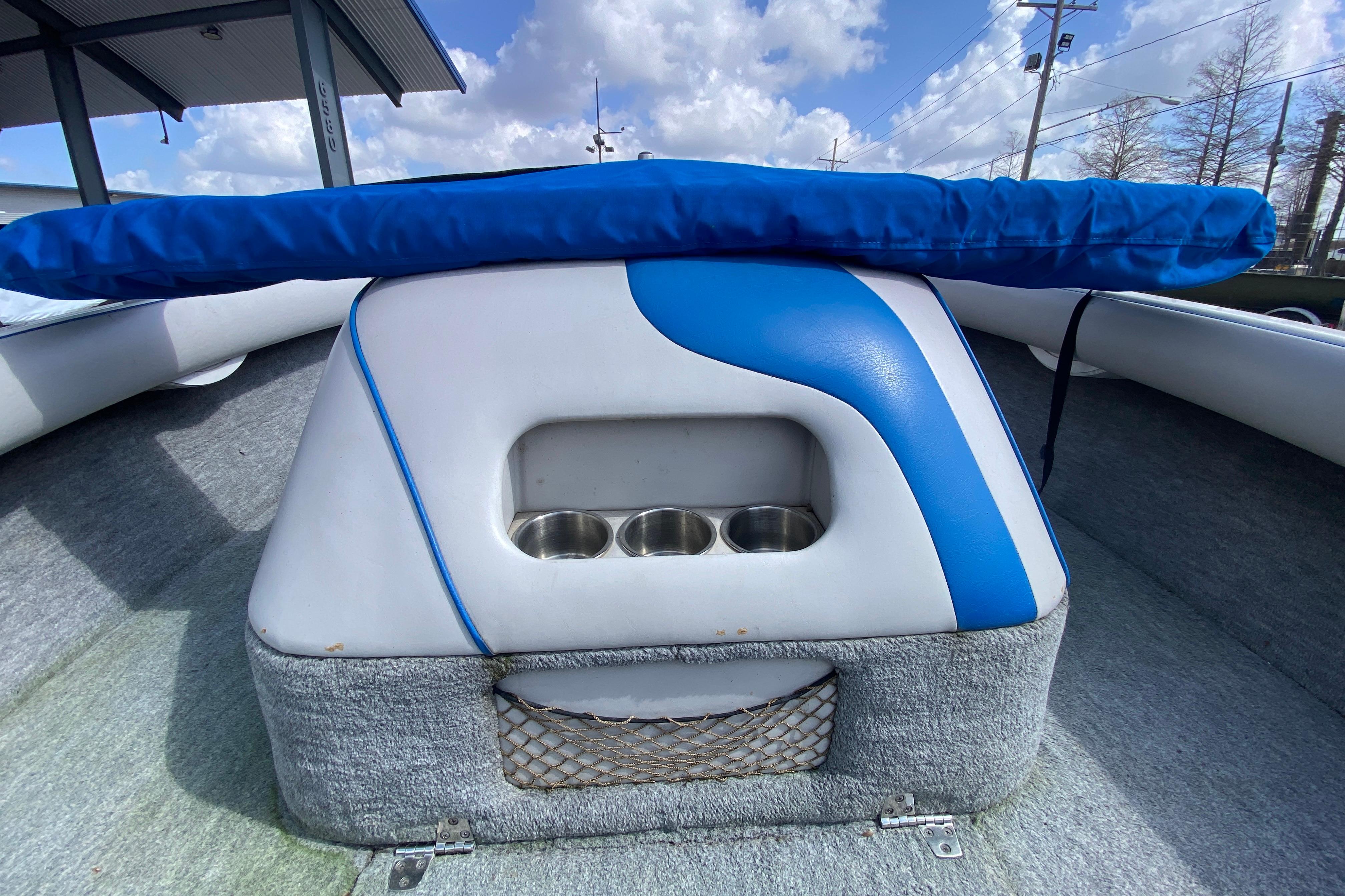 1997 Malibu Tantrum boat interior with blue and white seating, cup holders, and storage net.