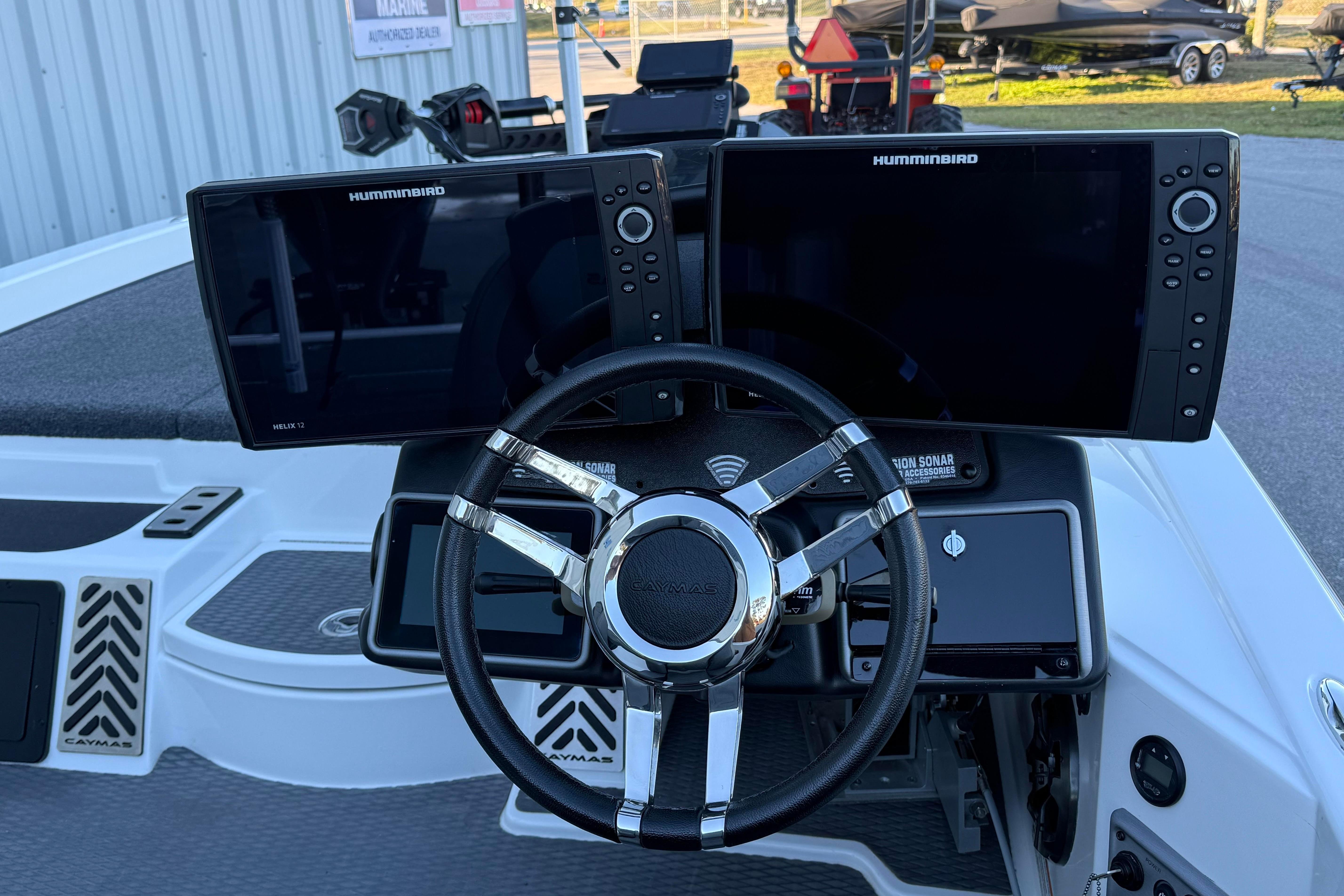 2022 Caymas CX 20 PRO boat dashboard with dual Humminbird displays and steering wheel.