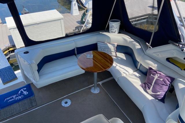 Luxurious 1994 Cruisers Yachts 3675 Esprit interior with cozy seating and nautical decor.