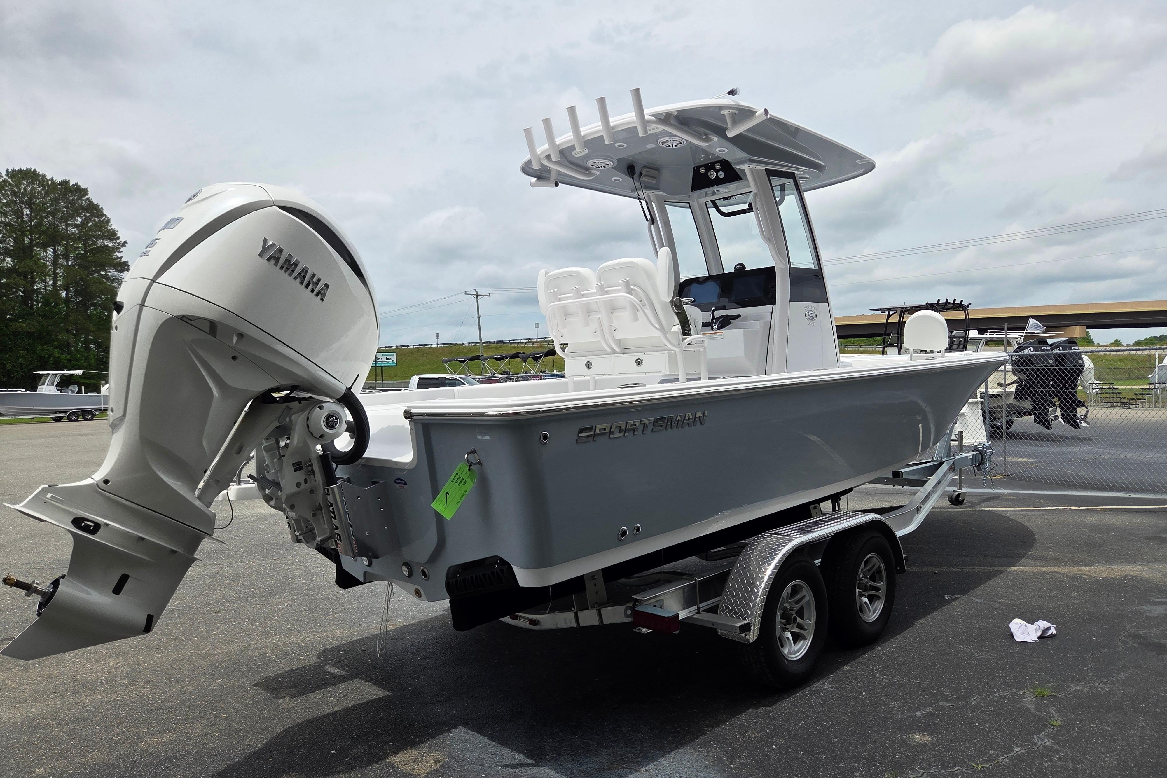 2026 Sportsman Masters 247 Bay Boat with Yamaha engine on trailer, parked outdoors.