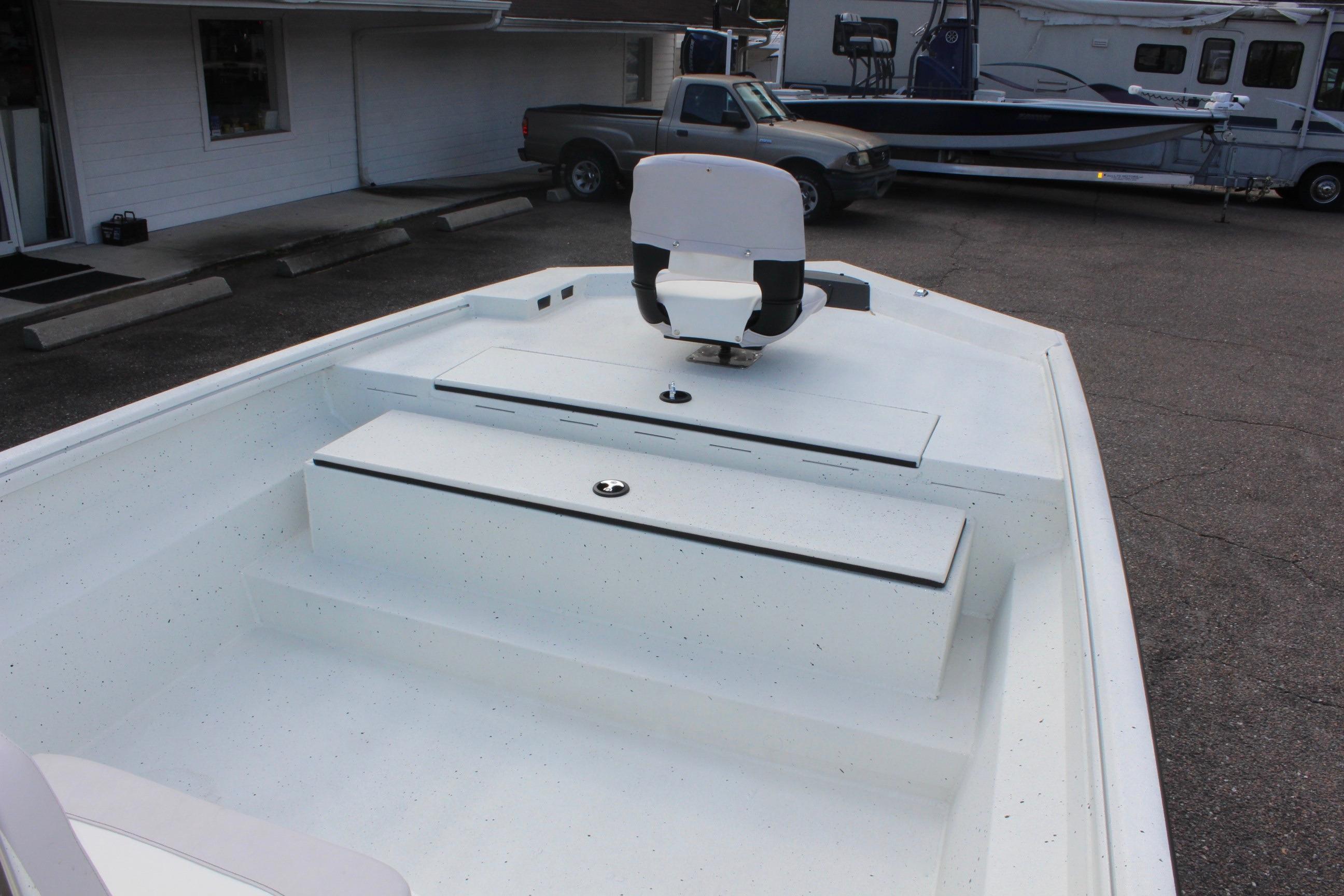 Interior view of 2025 Excel 2172 Stalker CC boat, featuring seating and storage compartments.