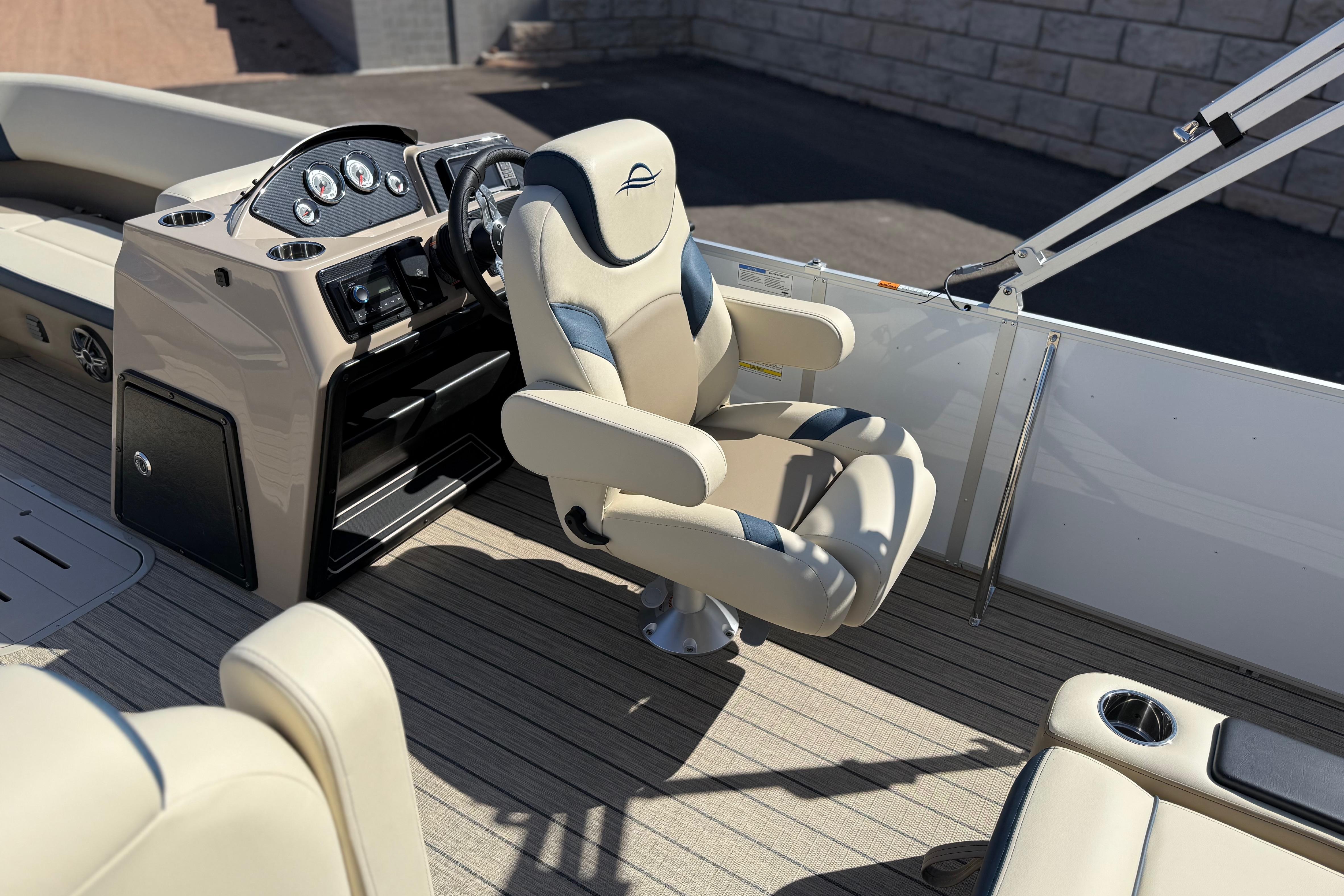 Luxury interior of 2026 SunCatcher Select 322SL boat with plush captain's chair.
