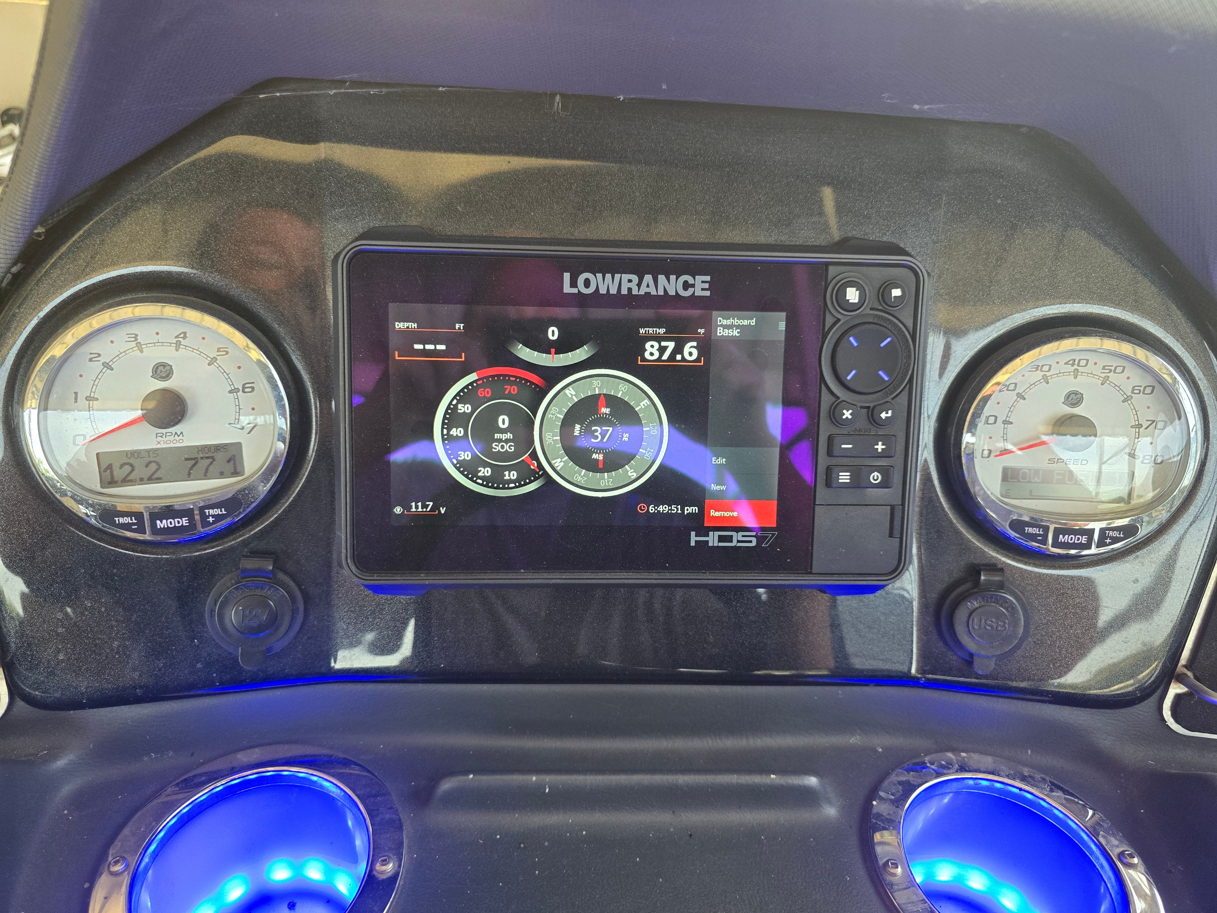 Dashboard of a 2021 Regency 230 LE3 boat with gauges and a Lowrance display.