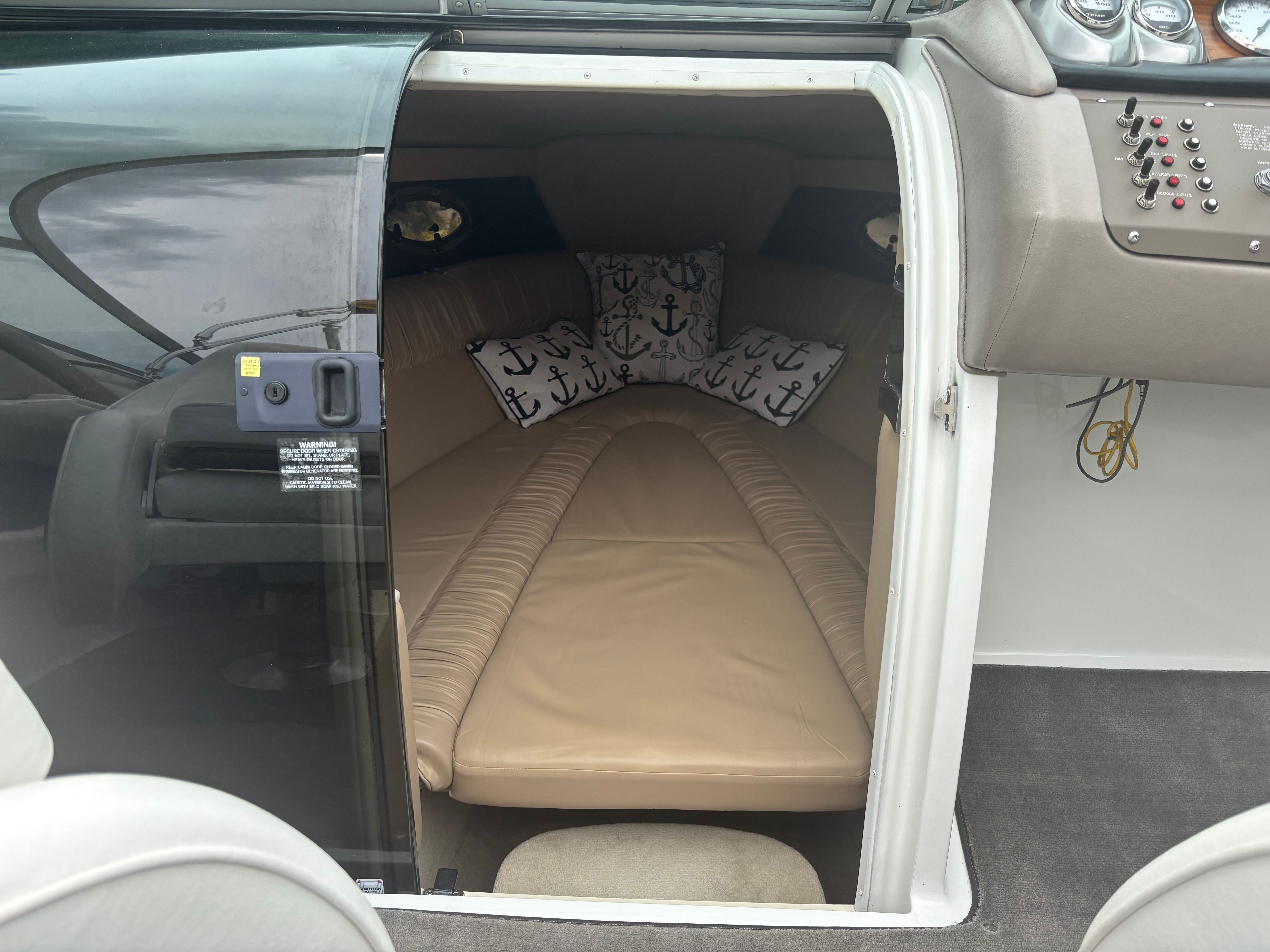 The image shows the interior of a 2005 Cobalt 255 with a cushioned lounging area.