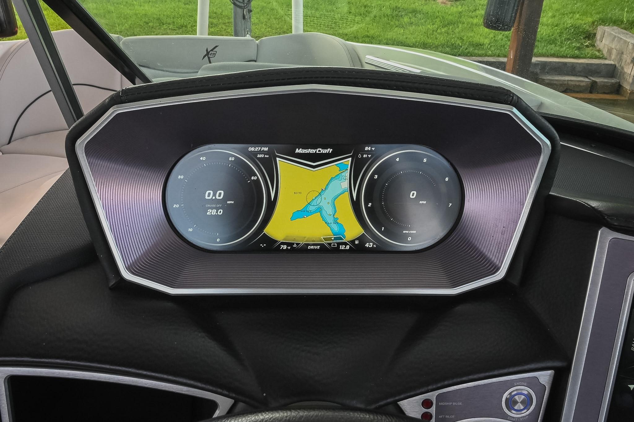 Dashboard of a 2018 MasterCraft X23 boat with digital display and navigation map.