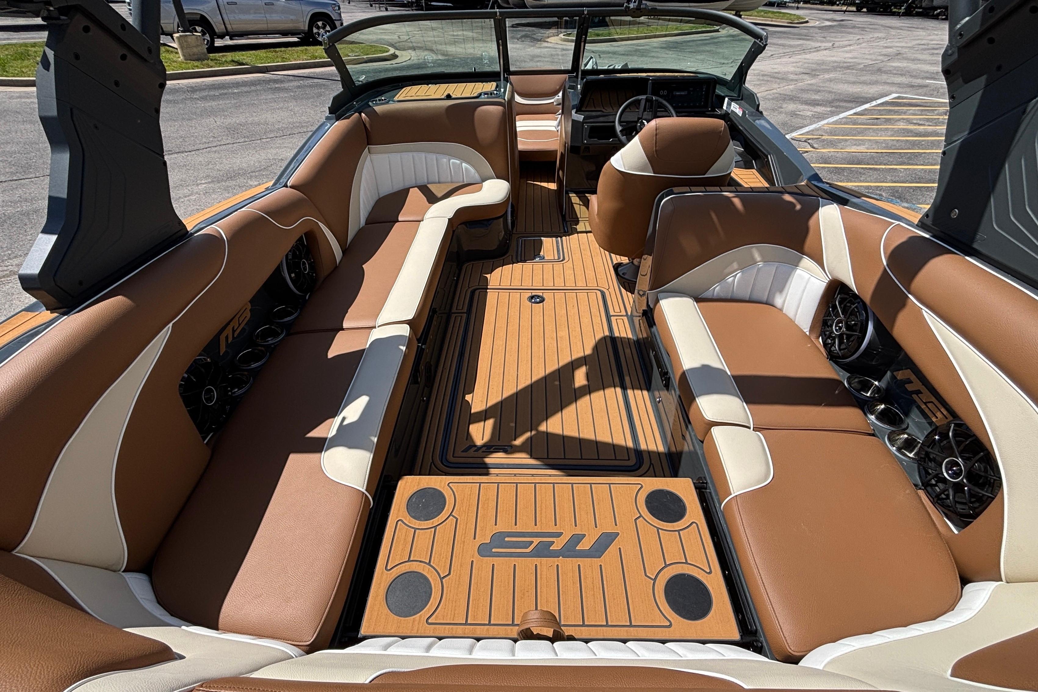 Luxurious interior of 2026 MB B52 23 Alpha boat with tan and white seating.