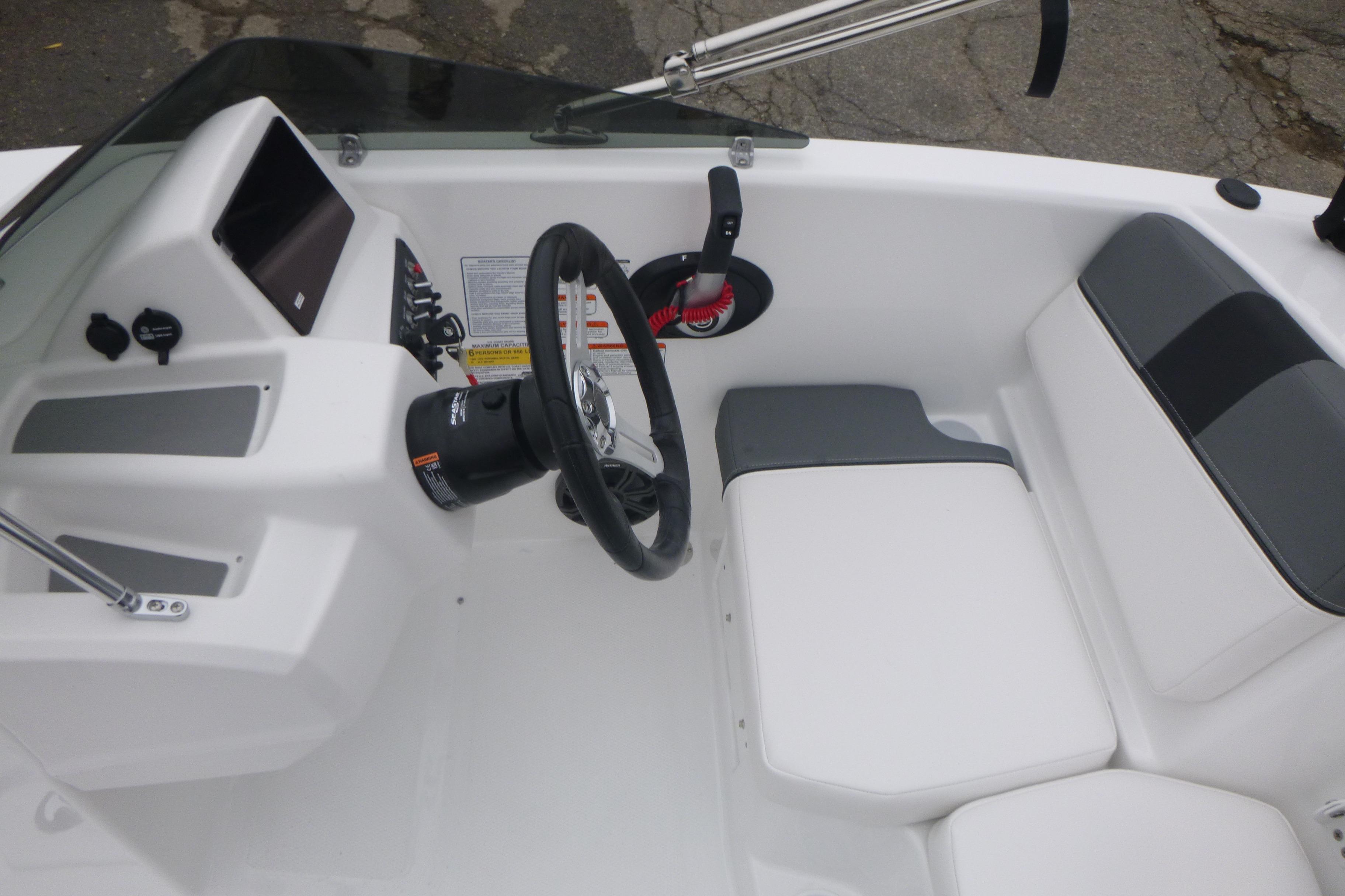 2026 Tahoe T16 boat interior with steering wheel and seating area.
