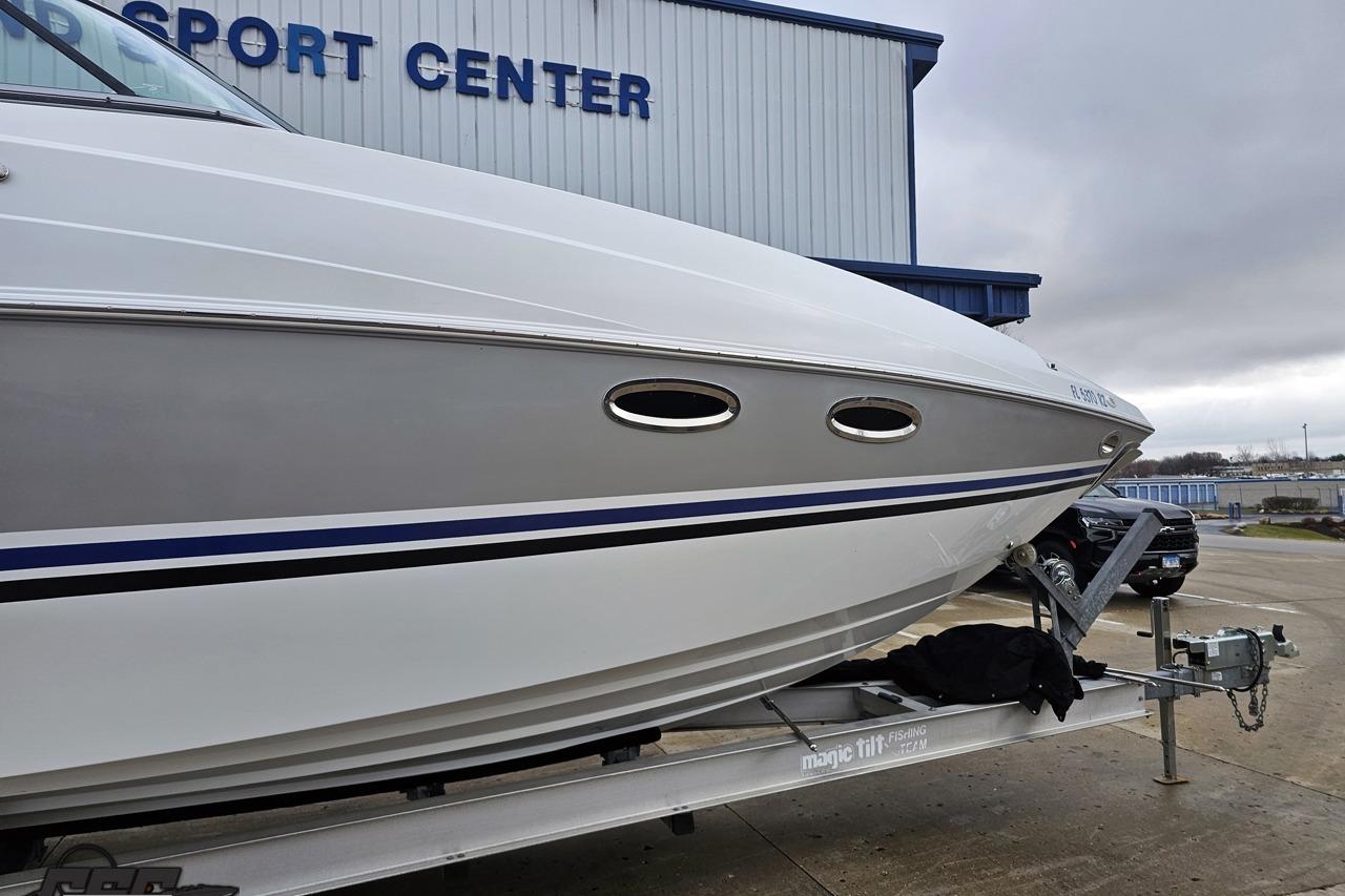 2008 Baja 335 Performance boat on trailer at a sports center.