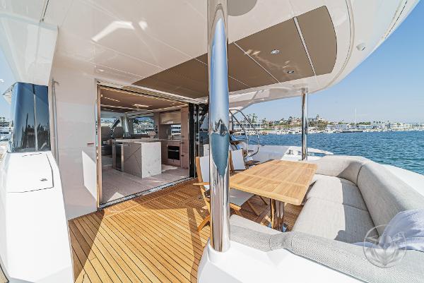 Luxurious Sunseeker Manhattan 68 yacht, 2025 model, featuring elegant outdoor seating and ocean views.