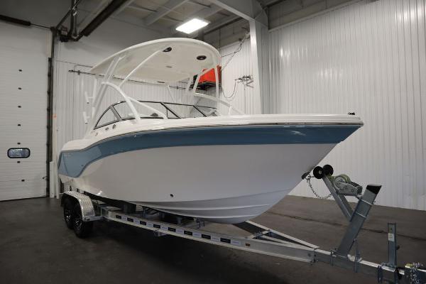 2025 Sea Fox 228 Traveler boat on trailer in indoor showroom.