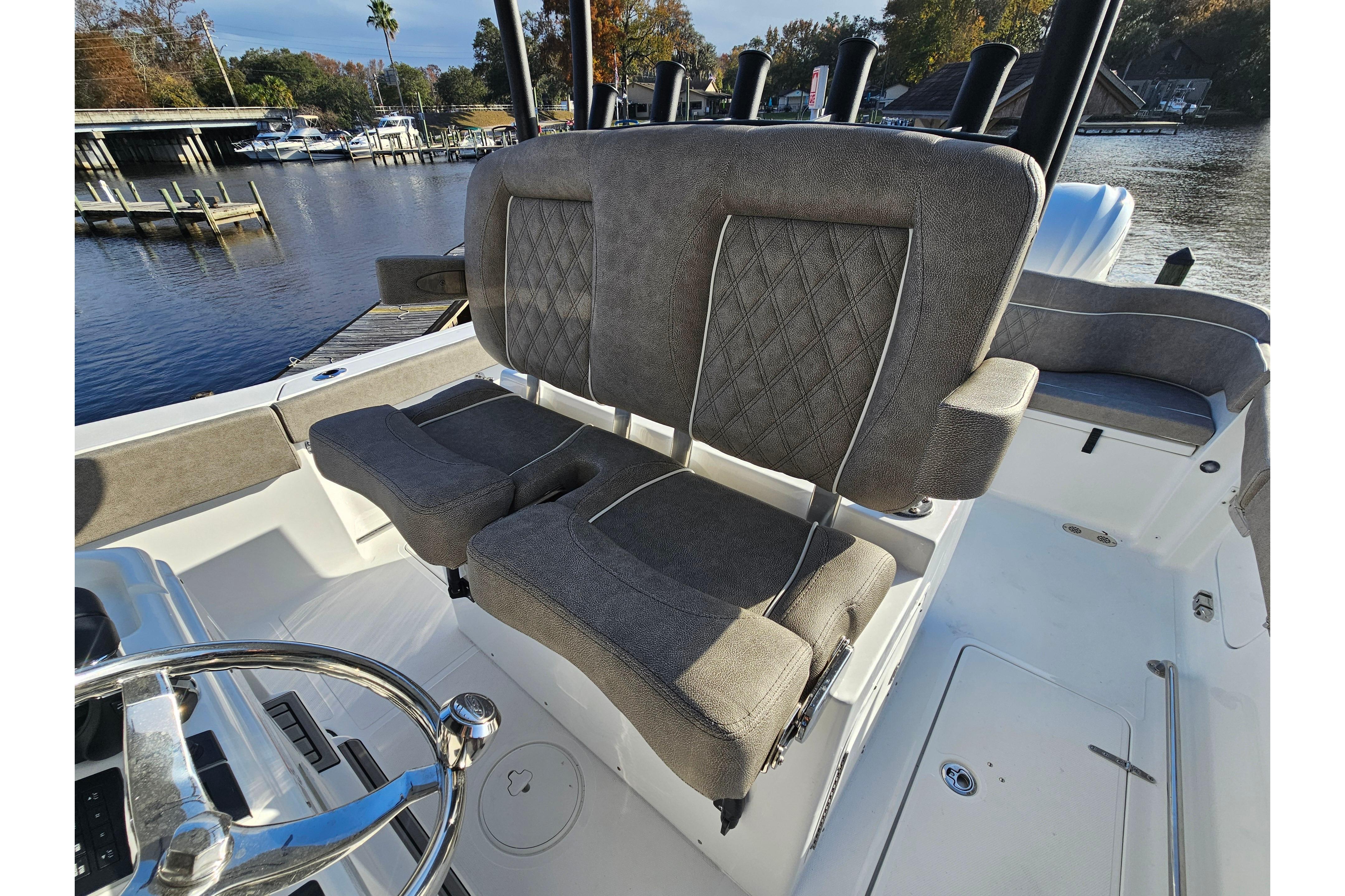 2026 Sea Hunt Ultra 285 SE boat interior with plush seating and scenic waterfront view.