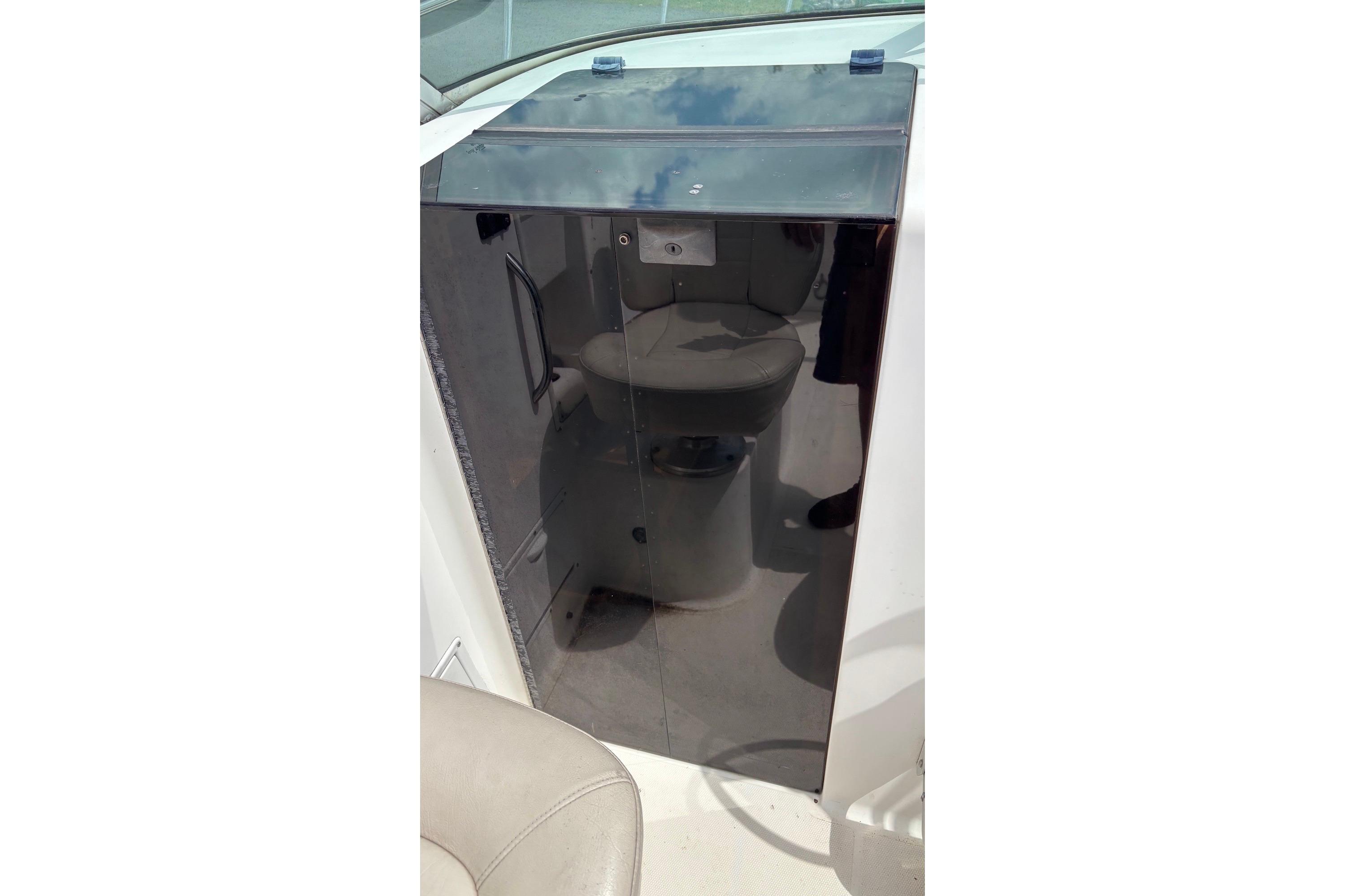 2002 Wellcraft 24 Walkaround boat interior with a compact cabin toilet.
