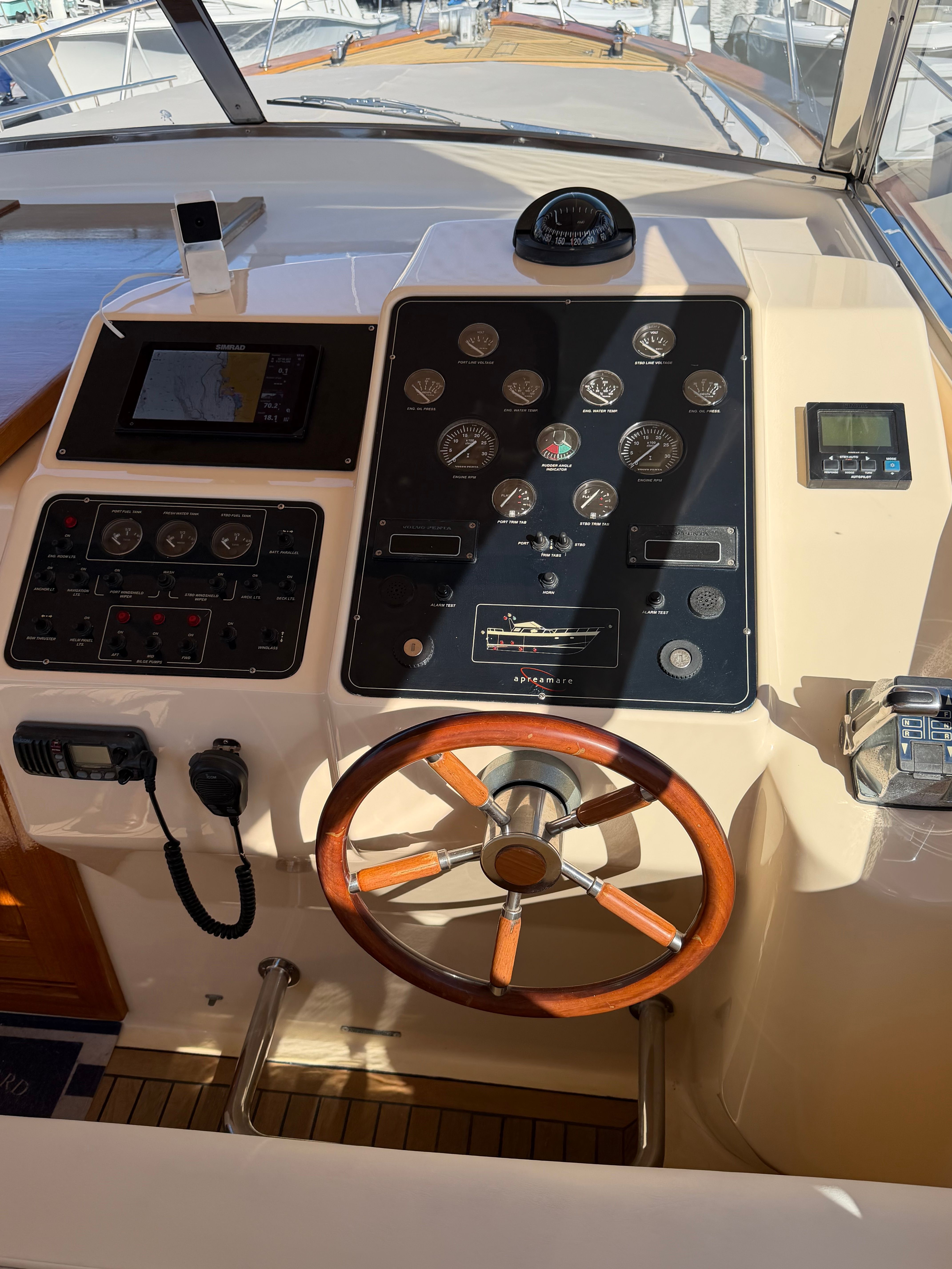 Helm of a 2003 Apreamare 11 with wooden steering wheel and instrument panel.