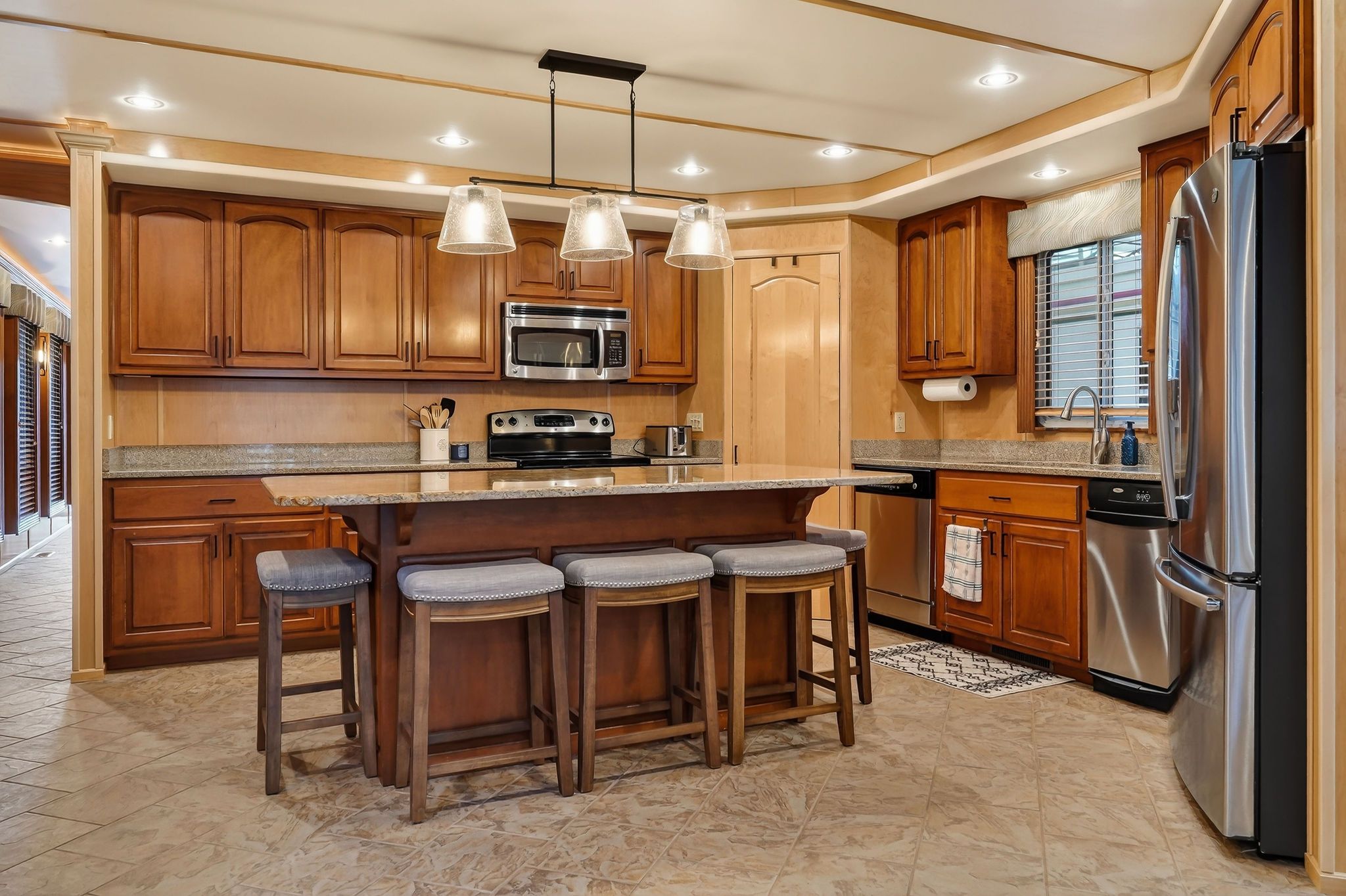Modern kitchen on a 2010 houseboat with wooden cabinets and island.