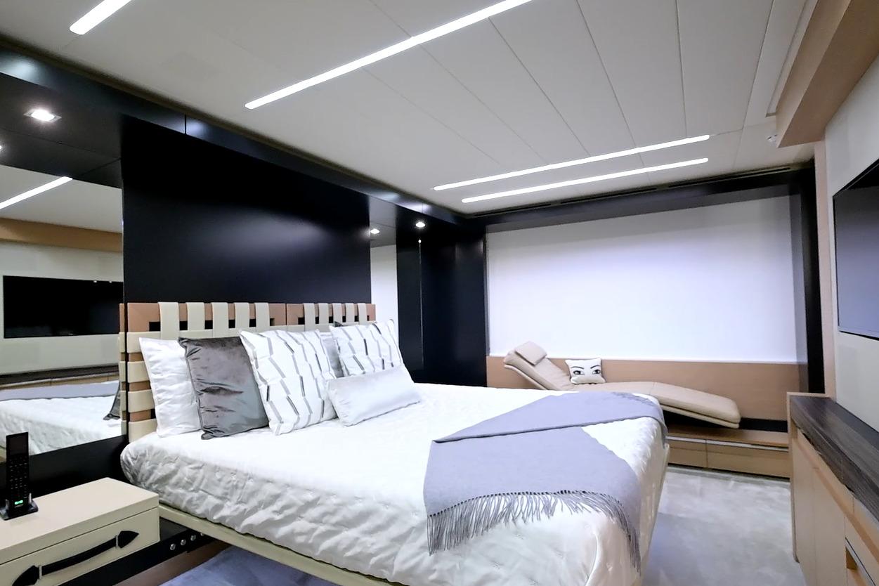 Luxurious bedroom interior on a 2015 Pershing 92 yacht, featuring modern design and elegant furnishings.