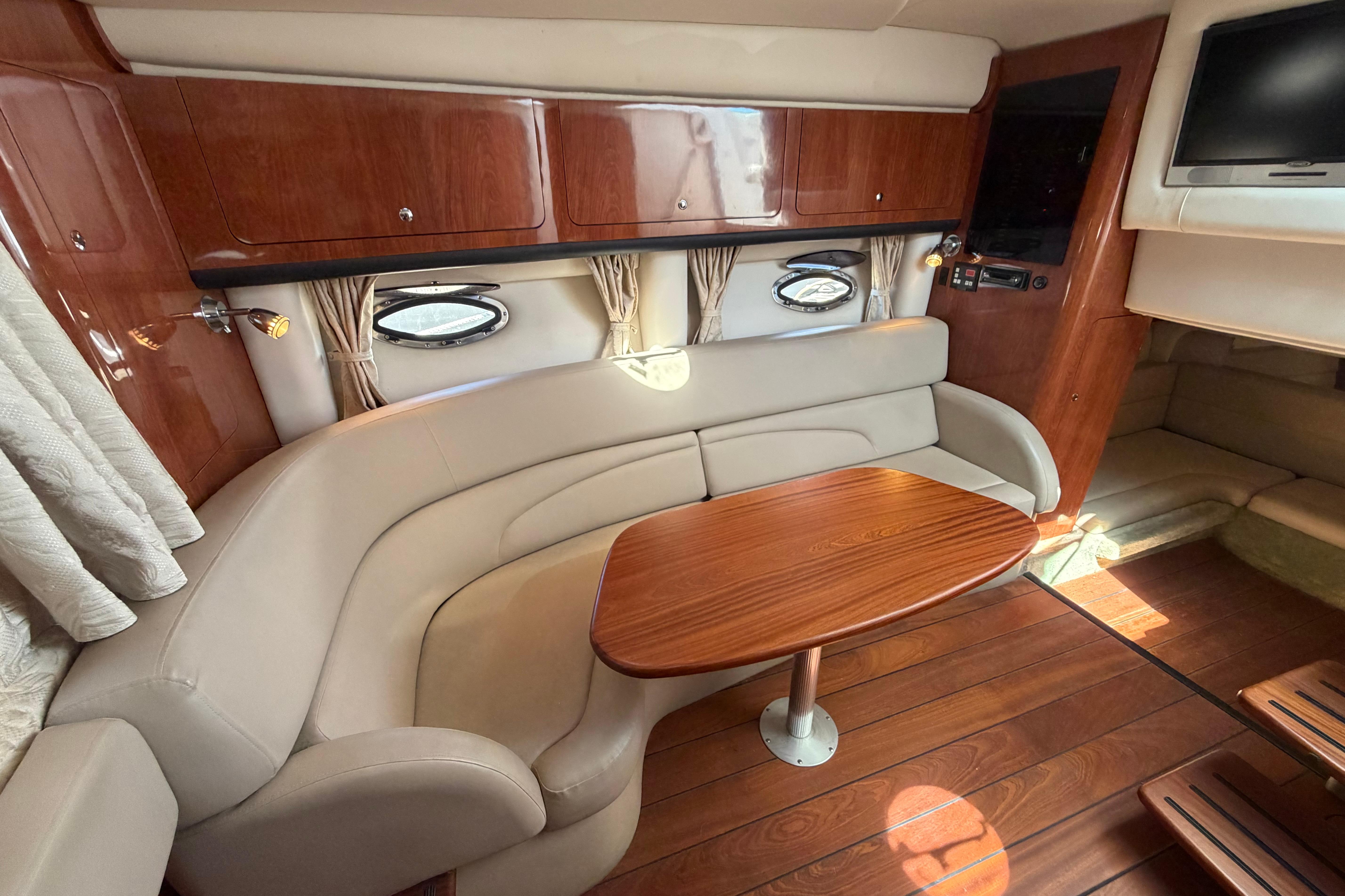 Luxurious 2008 Crownline 340 CR yacht interior with elegant wood and leather seating.