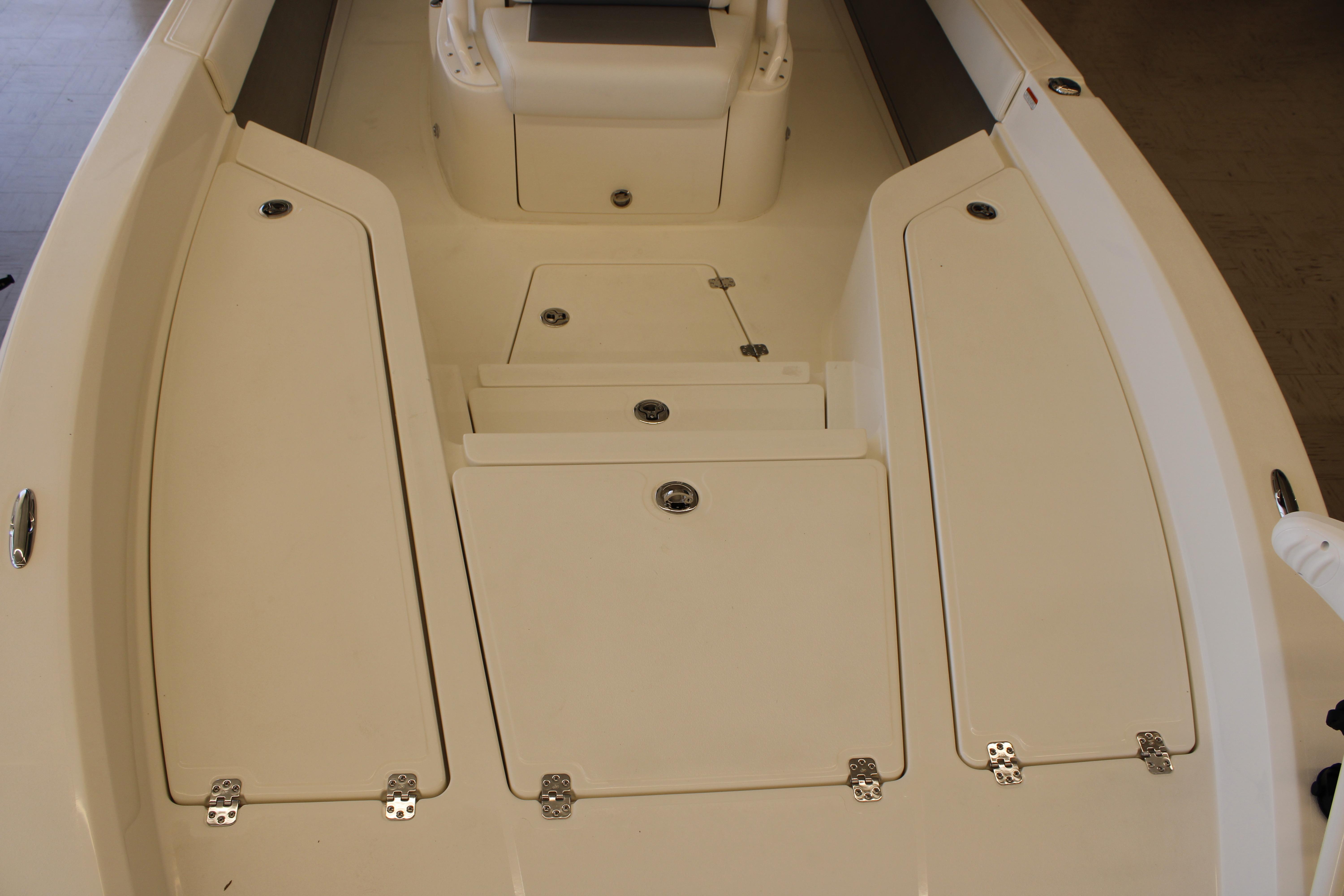 2026 Mako 24 APEX boat interior with storage compartments and seating area.
