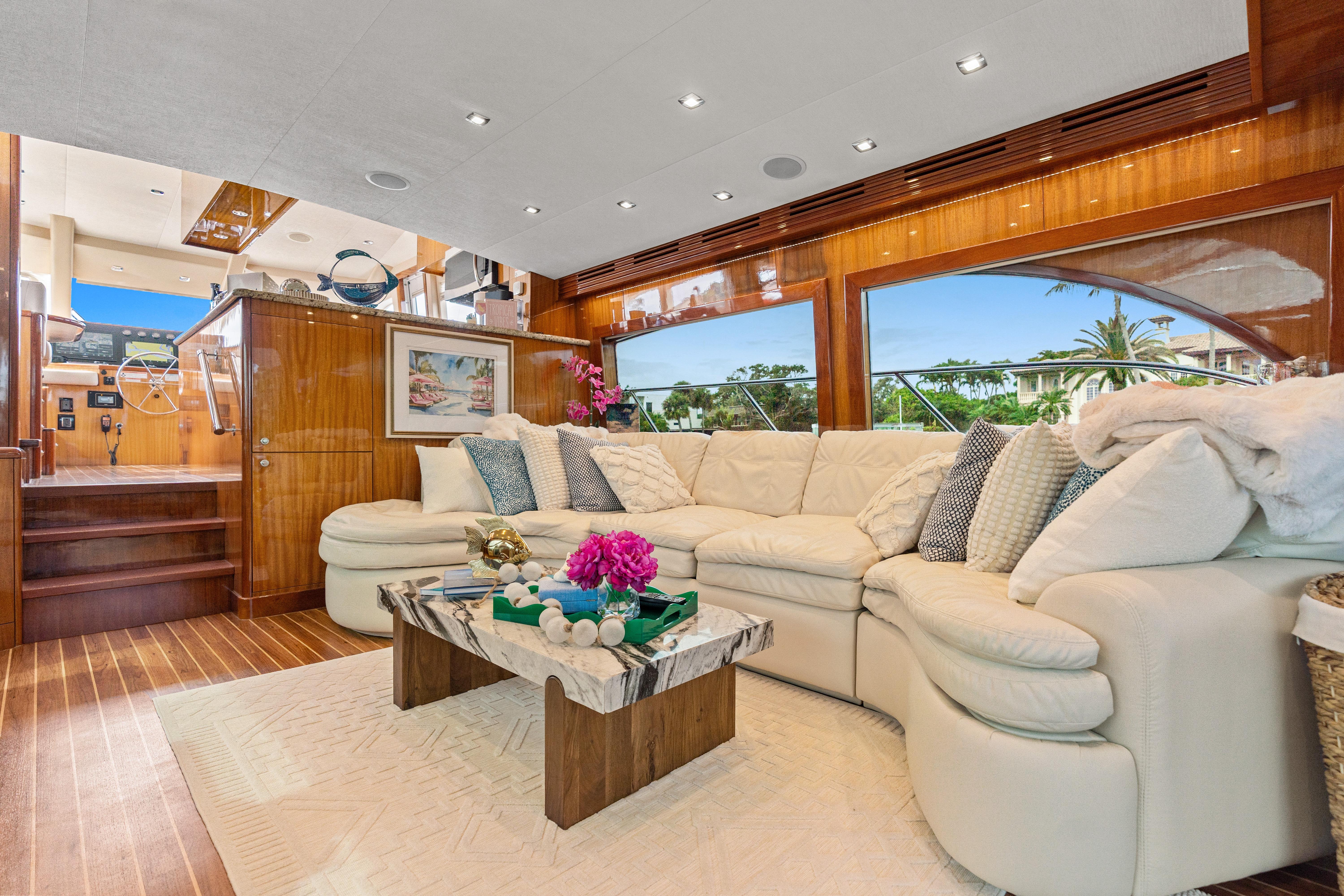 Luxurious interior of 2008 Hatteras 64 Motor Yacht with plush seating and elegant decor.