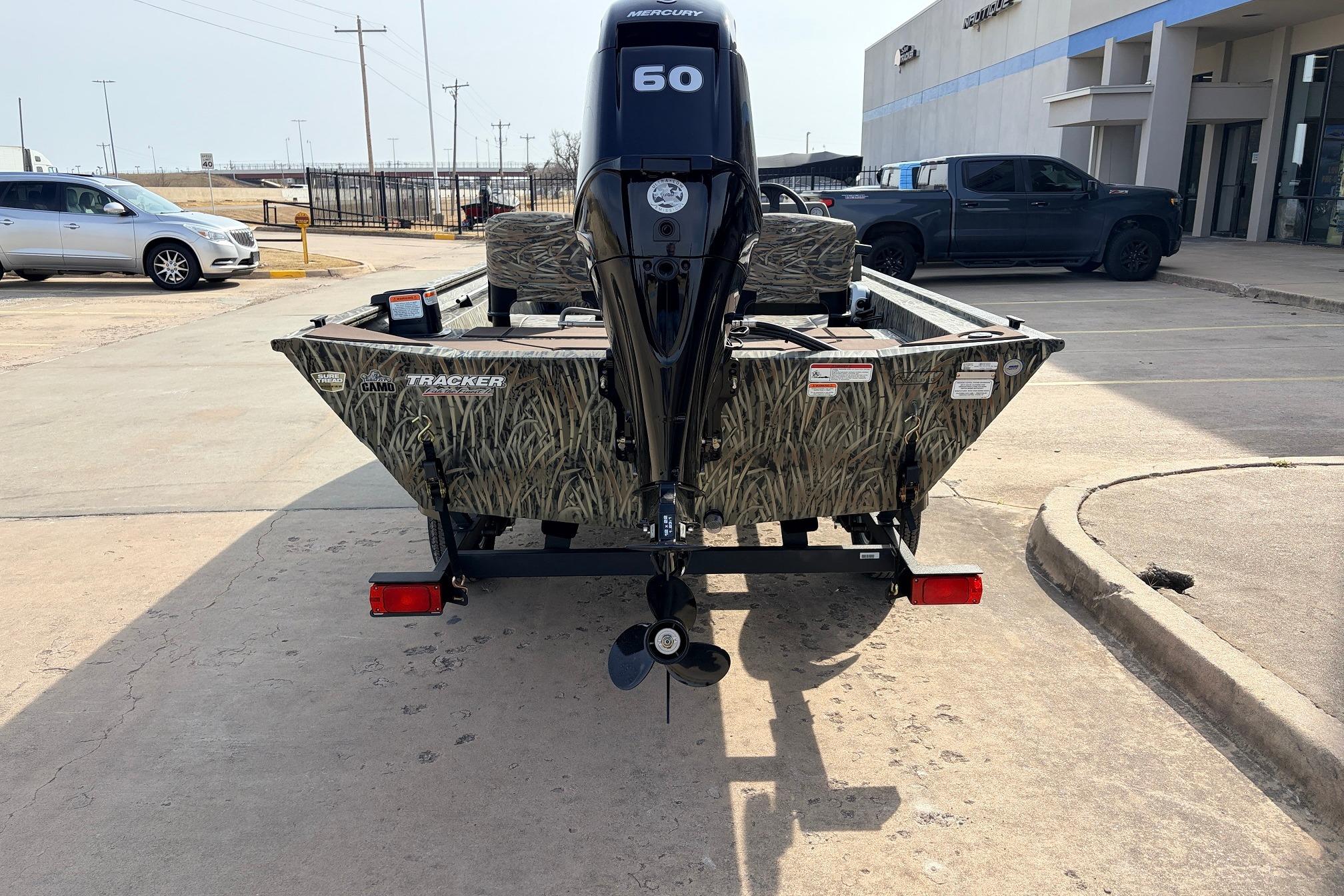 2026 Tracker Grizzly 1754 SC boat with camo design and Mercury 60 engine.