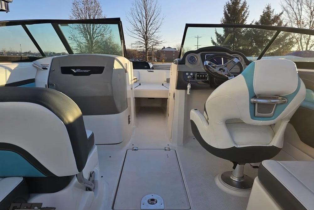 2016 CHAPPARRAL 243 boat interior with steering wheel and seating, showcasing modern design.