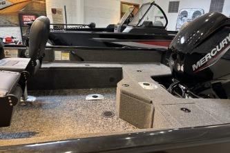 2026 Tracker Pro Guide V-16 WT boat with Mercury engine, showcased indoors.