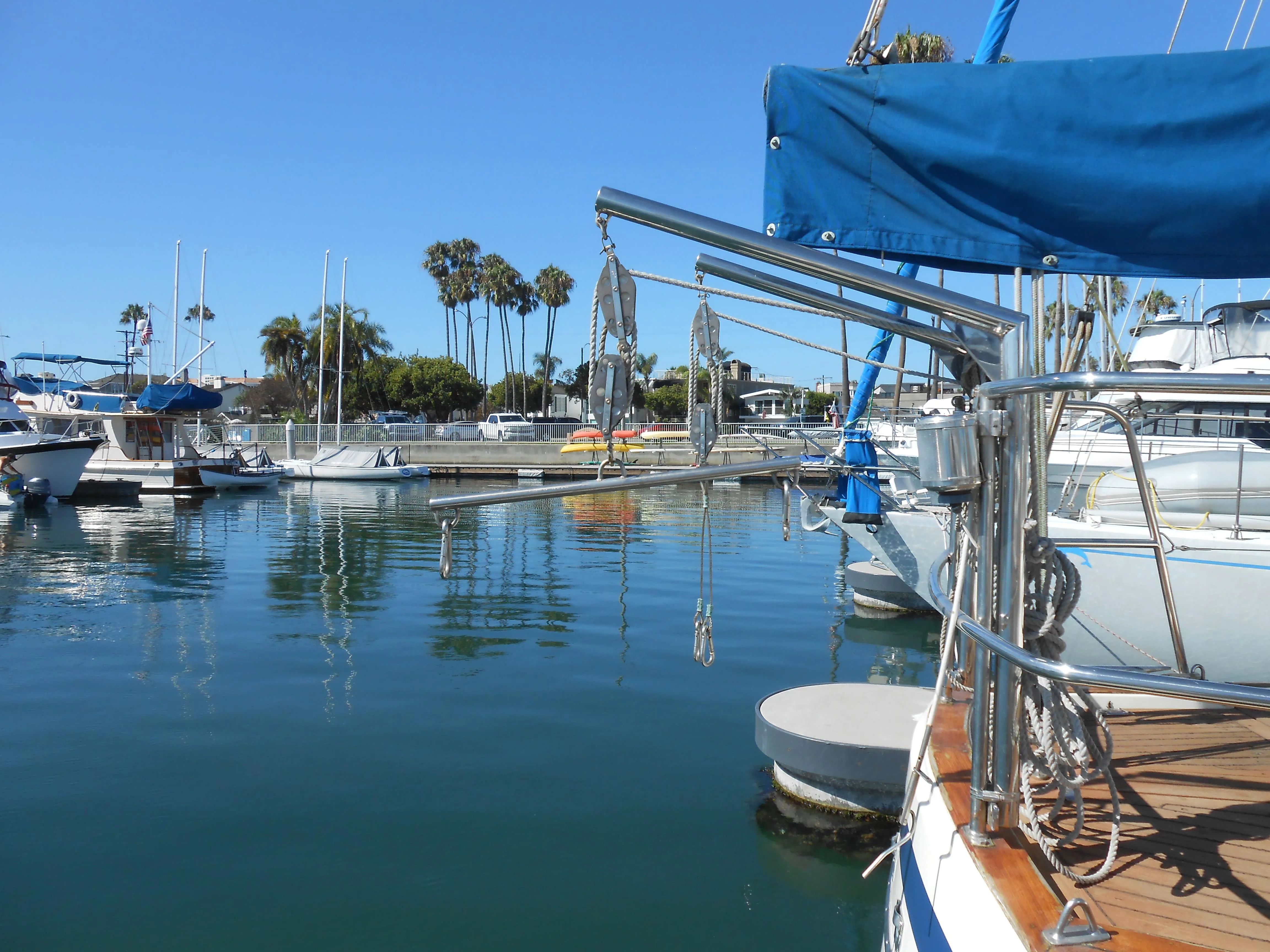 1985 Contest 41 Ketch in sunny marina with palm trees.