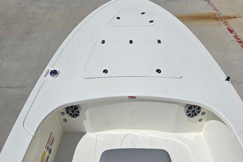 2026 Mako 18 Pro Skiff boat deck with storage compartments and speakers.