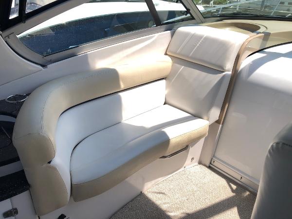 Interior of a 2008 Four Winns V338 with beige upholstered seating and carpeted floor.