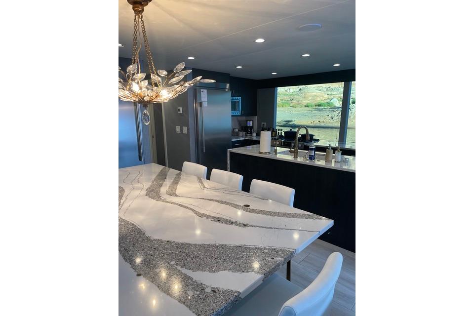 Luxurious kitchen interior on Adonia's 2021 "The Queen Elizabeth" yacht, featuring elegant marble countertops.