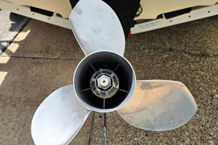 Propeller of a 2007 Sea Ray 205 Sport boat on a concrete surface.