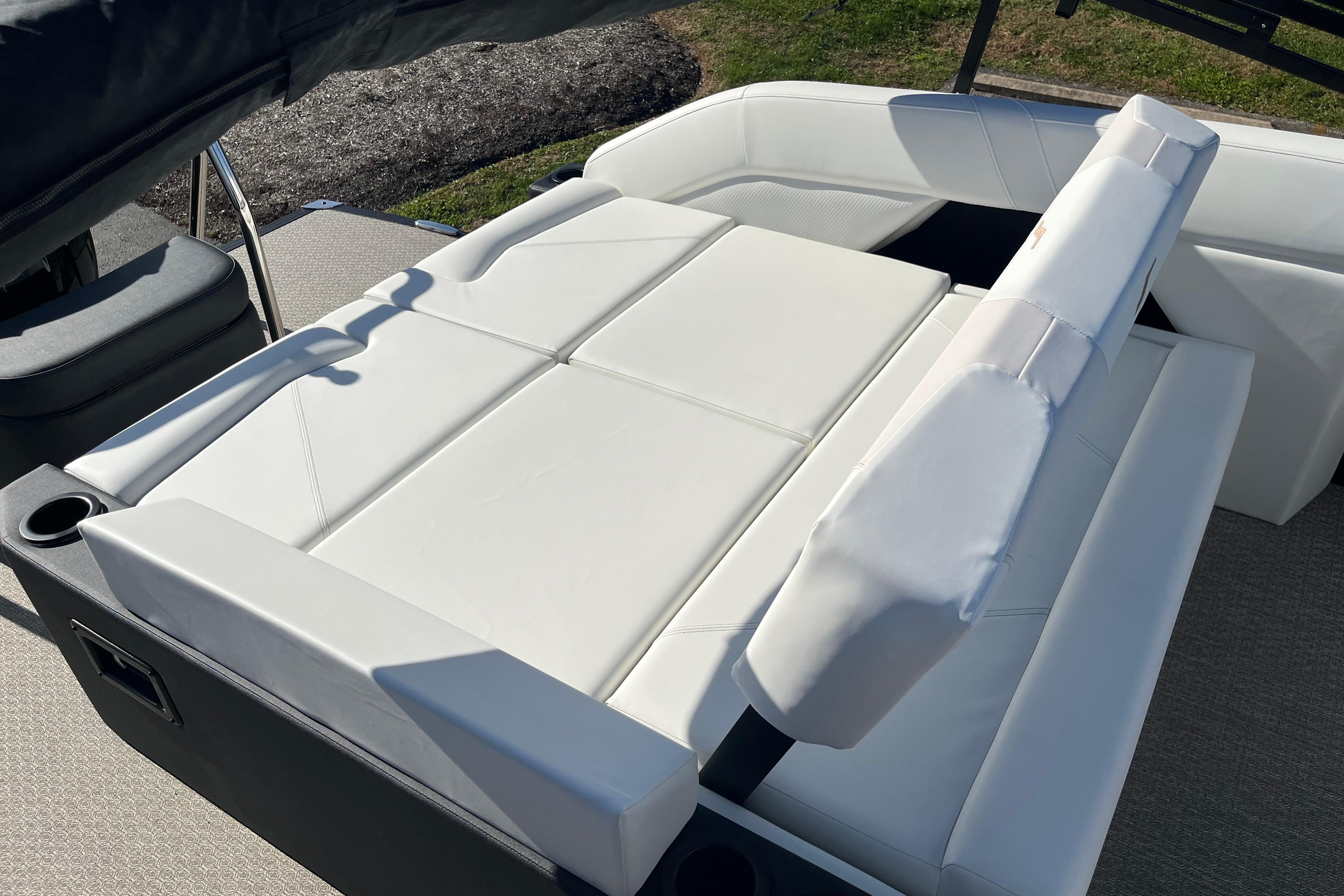 Luxurious white seating on 2026 Evotti 523CS boat, featuring adjustable backrests and cup holders.