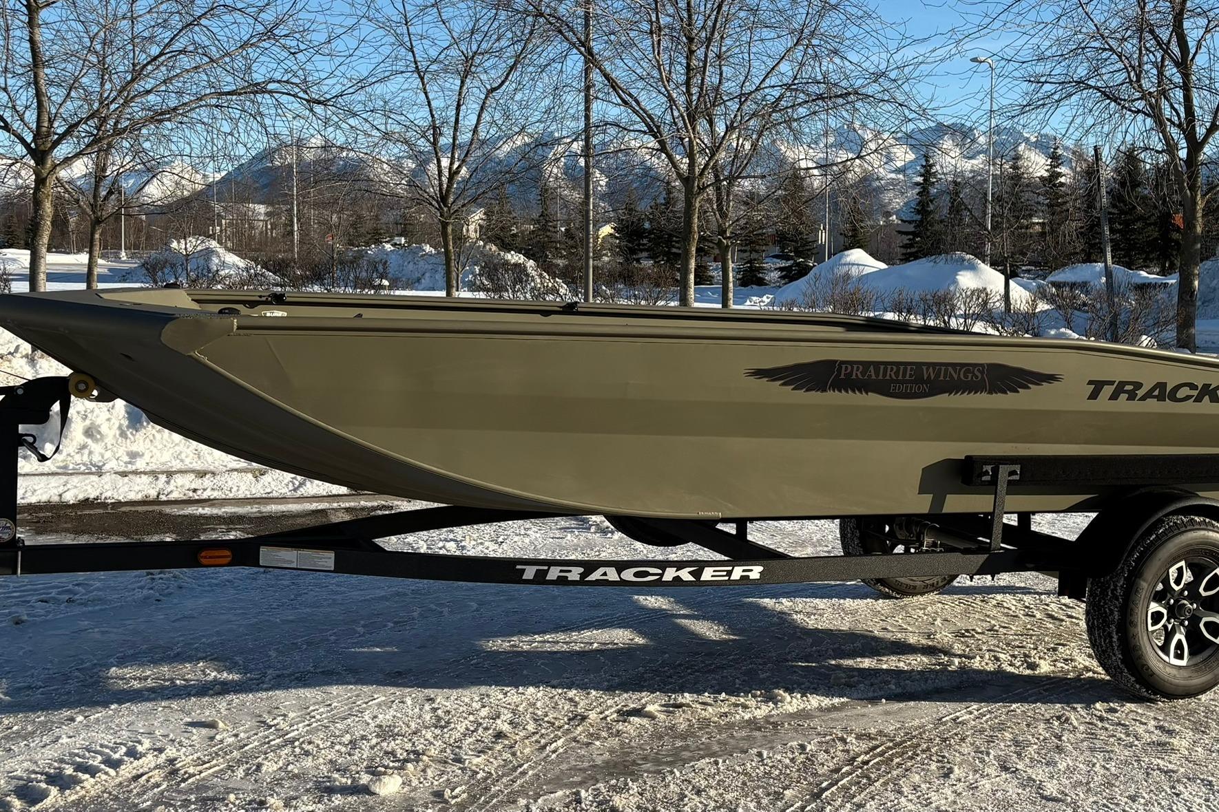 2025 Tracker Grizzly 1650 T Prairie Wings Edition boat on snowy landscape.