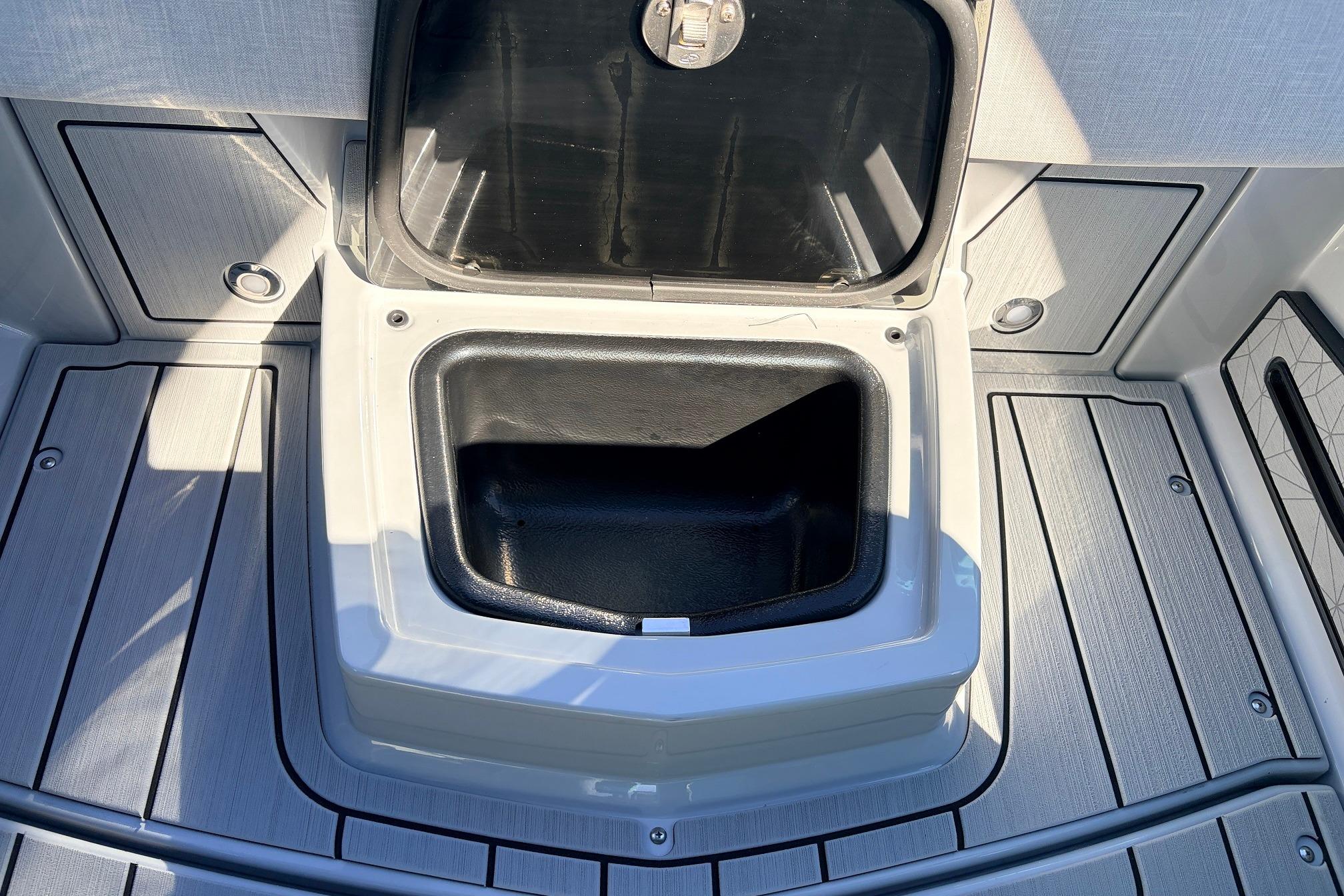 Open storage compartment on 2026 Nautique Super Air Nautique G23 boat deck.