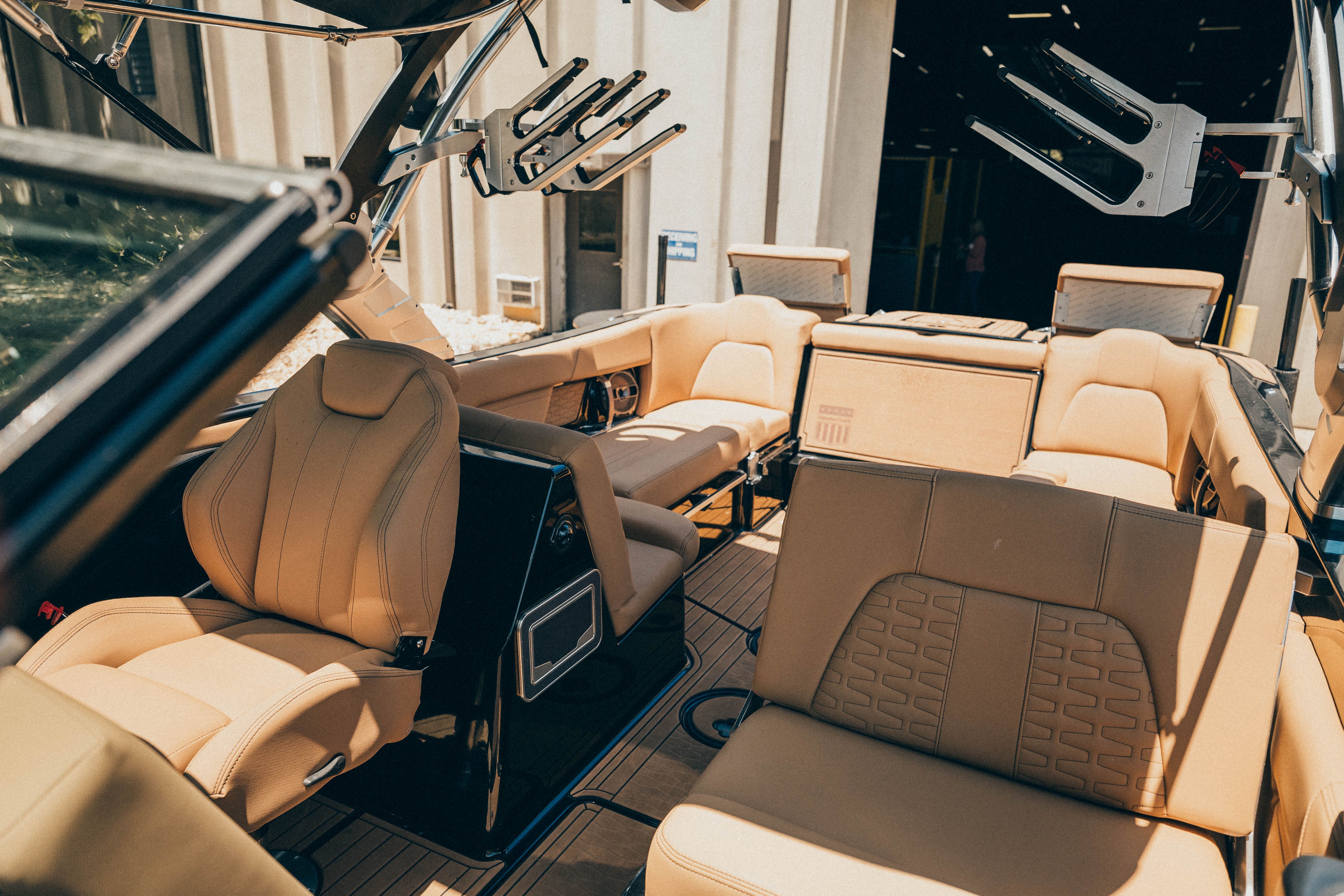 The image shows the interior of a 2021 MasterCraft X26 boat with beige leather seating.