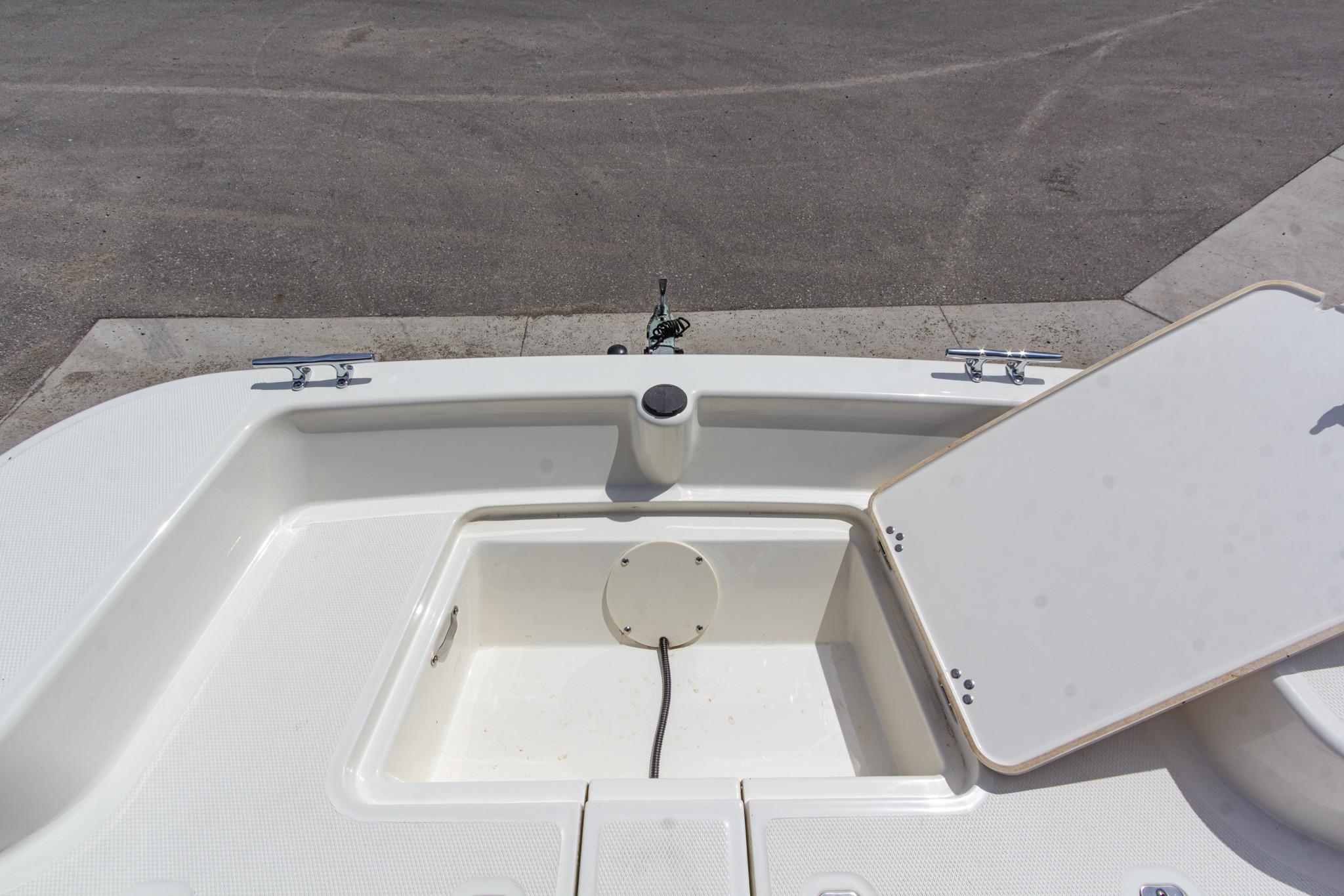 2020 Mako Pro Skiff 15 CC boat deck with storage compartment open.