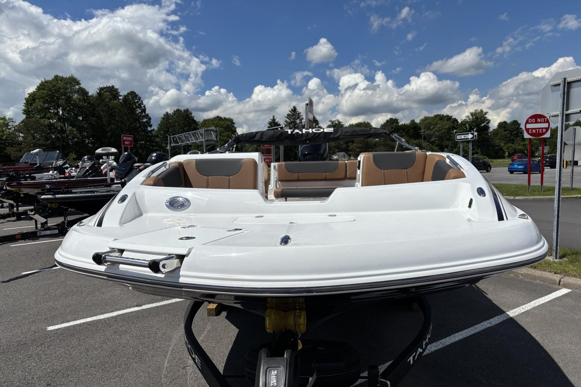 2026 Tahoe 1950 boat displayed in a parking lot under a partly cloudy sky.