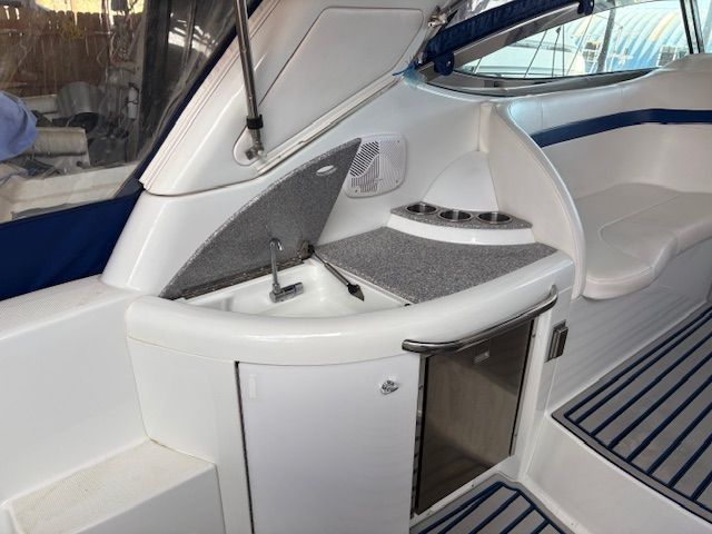 The 2007 Formula 34 Performance Cruiser features a compact onboard kitchen with a sink and refrigerator.