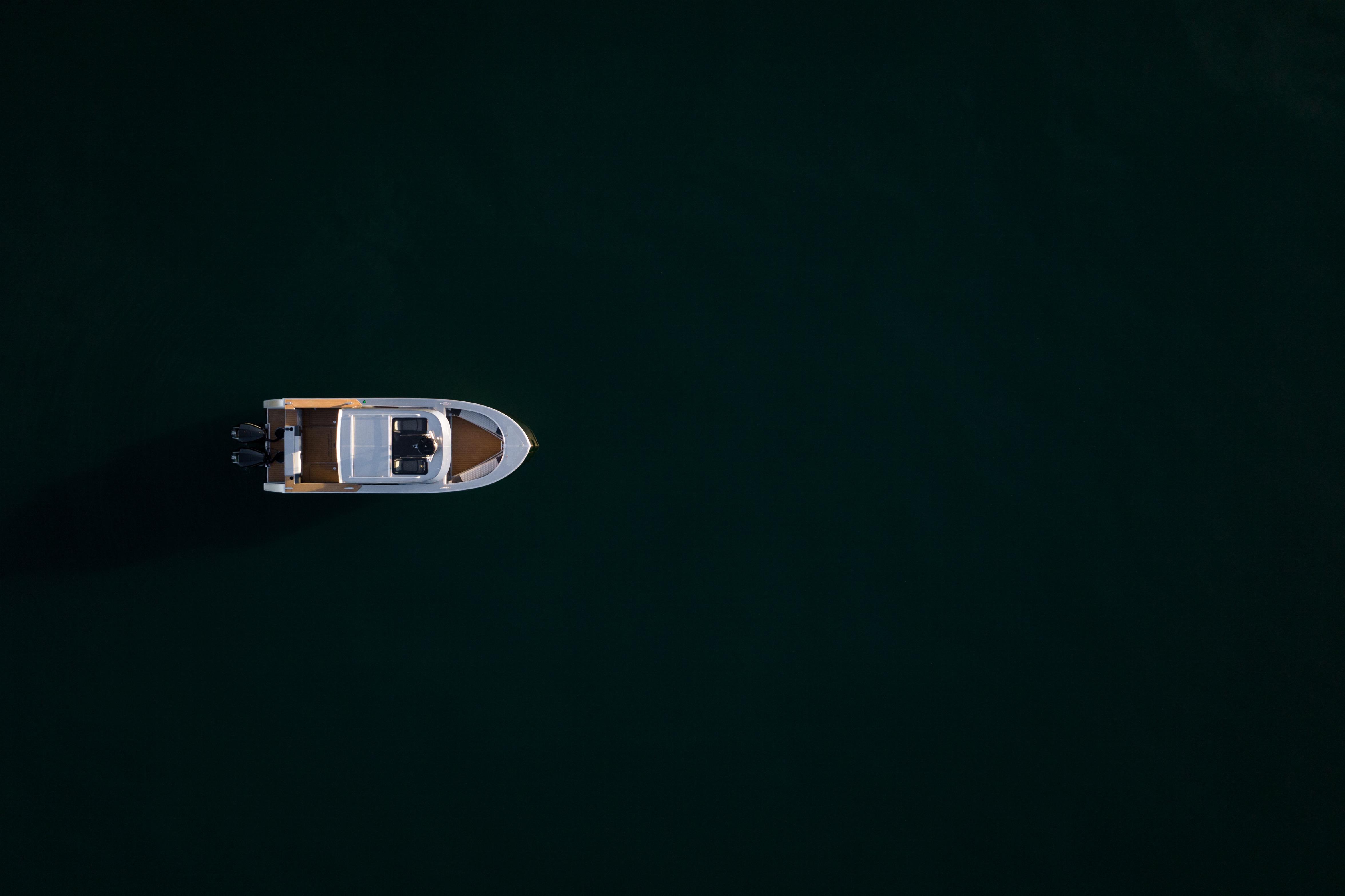 Aerial view of 2026 Jasper Marine Defender 22 boat on dark water.