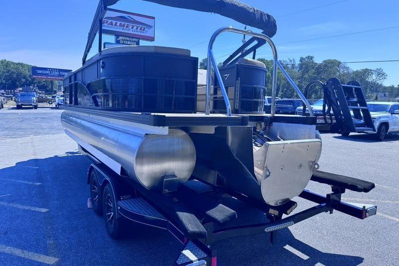 2027 Manitou Aurora 23 RF SHP pontoon boat on trailer, rear view.