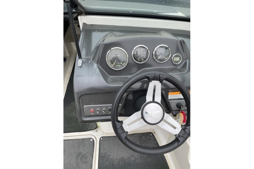 Steering wheel and dashboard of a 2015 Sea Ray 210 SLX boat.