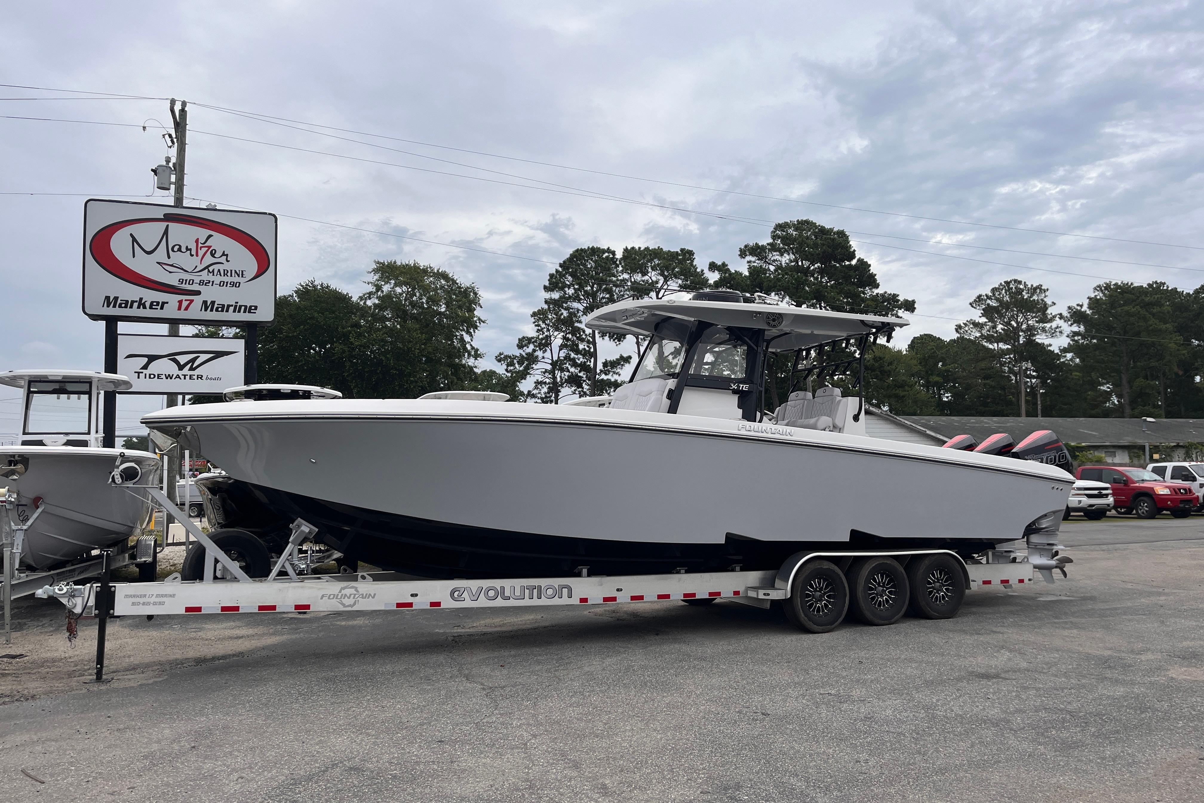 2024 Fountain 34 Tournament Edition boat on trailer at Marker 17 Marine dealership.